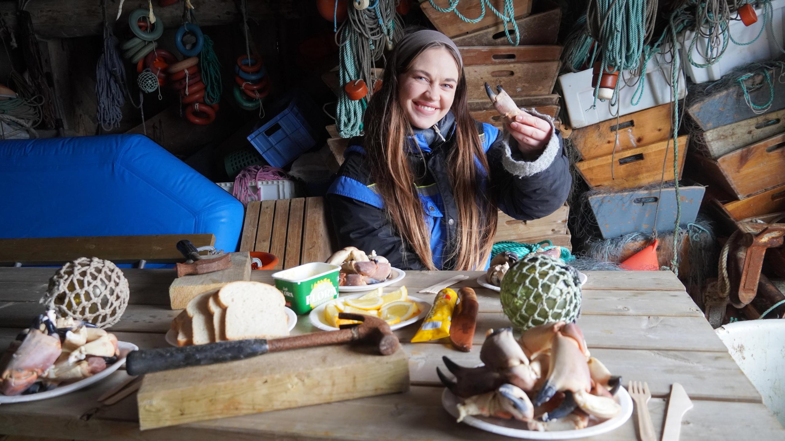 A woman eating crab meat.