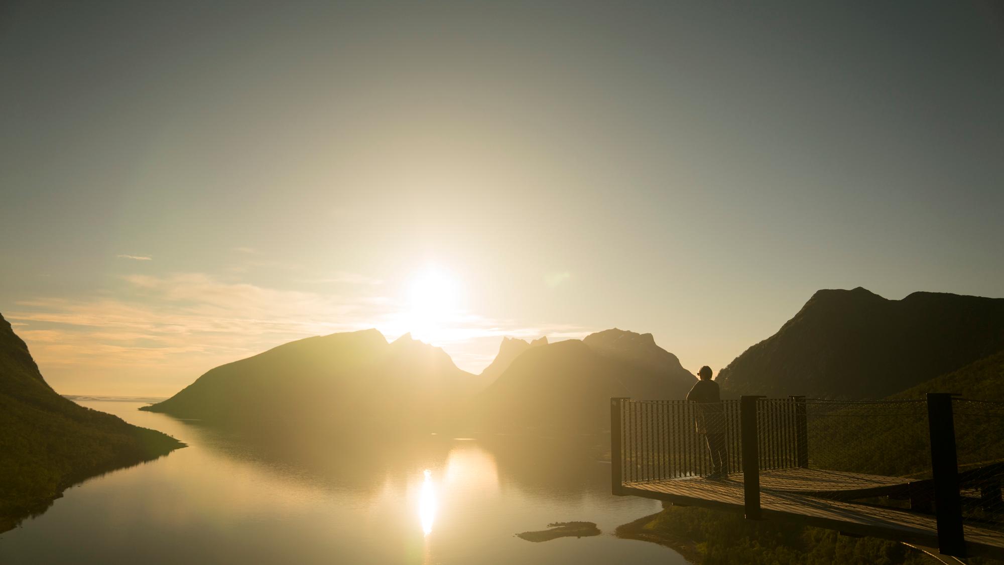 Person watching the midnight sun on the Bergsbotn viewpoint