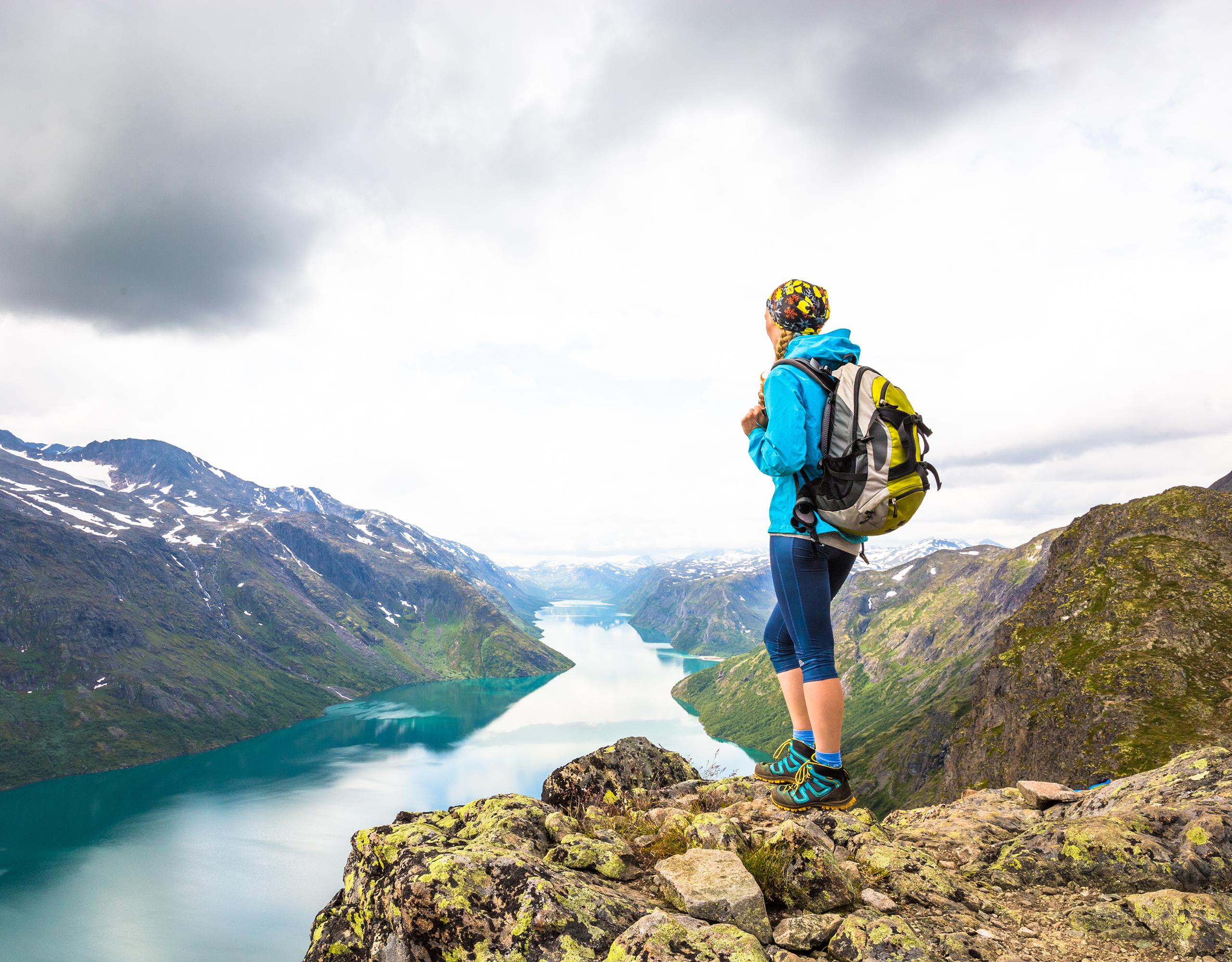 A woman enjoying the view of Lake Gjende from the top of Besseggen in Jotunheimen, Eastern Norway