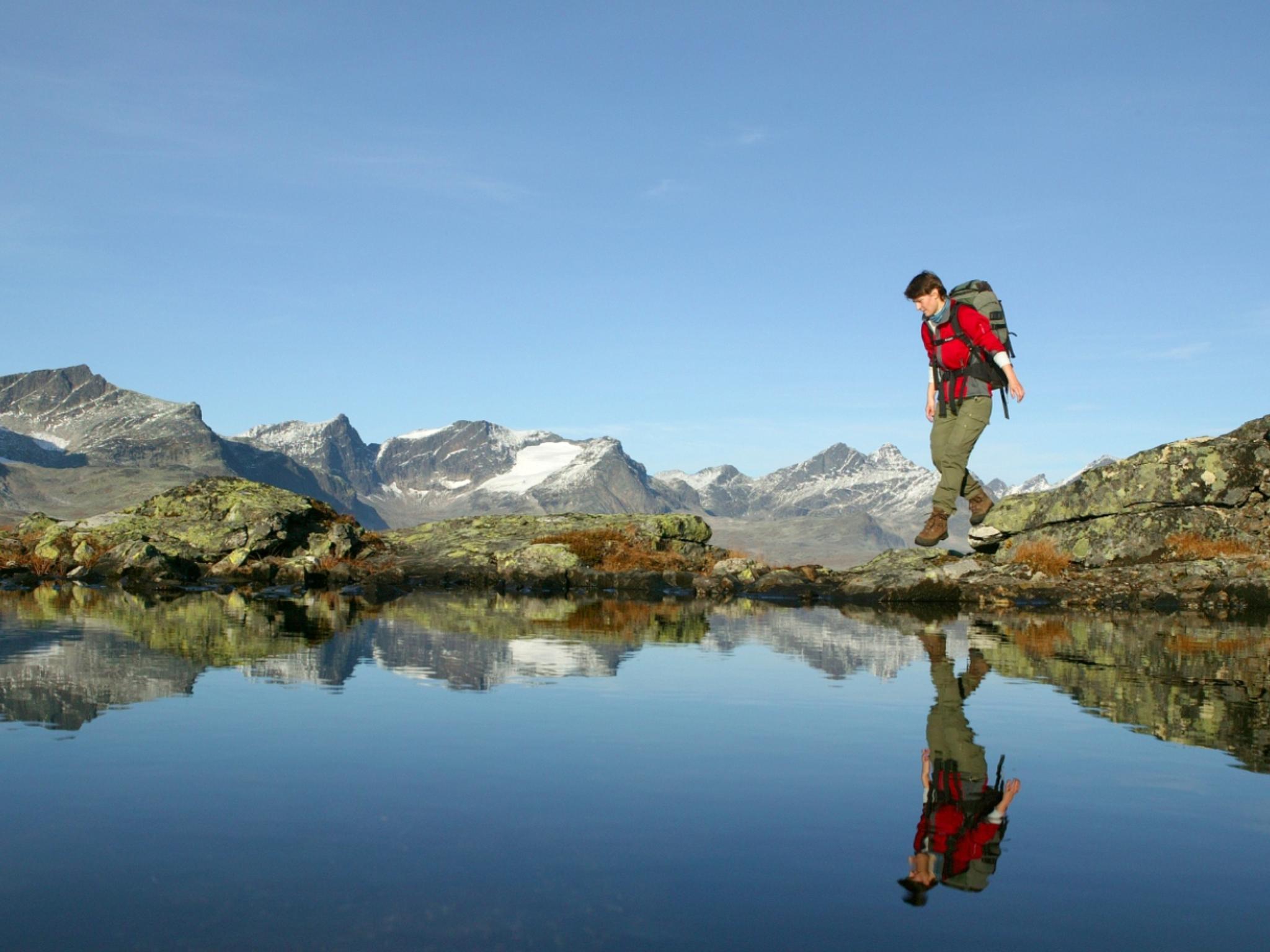 Woman walking the Besseggen ridge in Valdres
