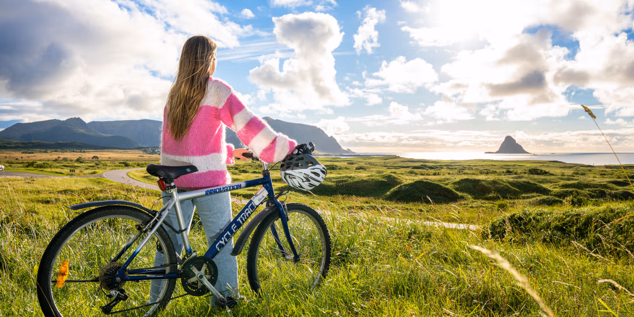 A woman biking along Norwegian Scenic Route Andøya in Vesterålen