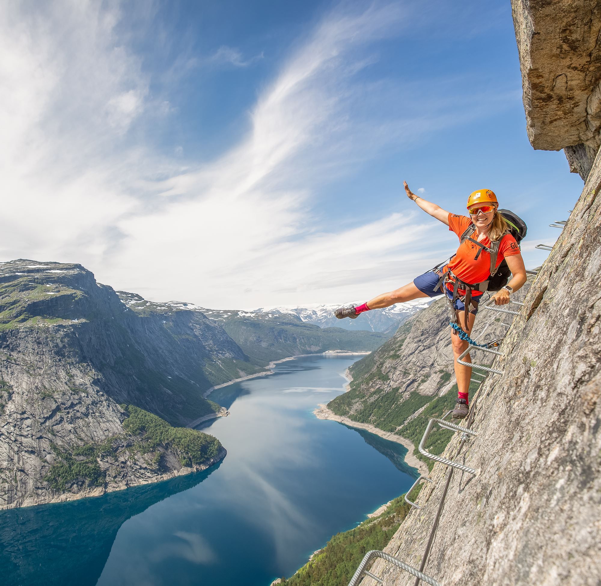 Active holiday in Norway: Woman climbing the Trolltunga via ferrata in Fjord Norway