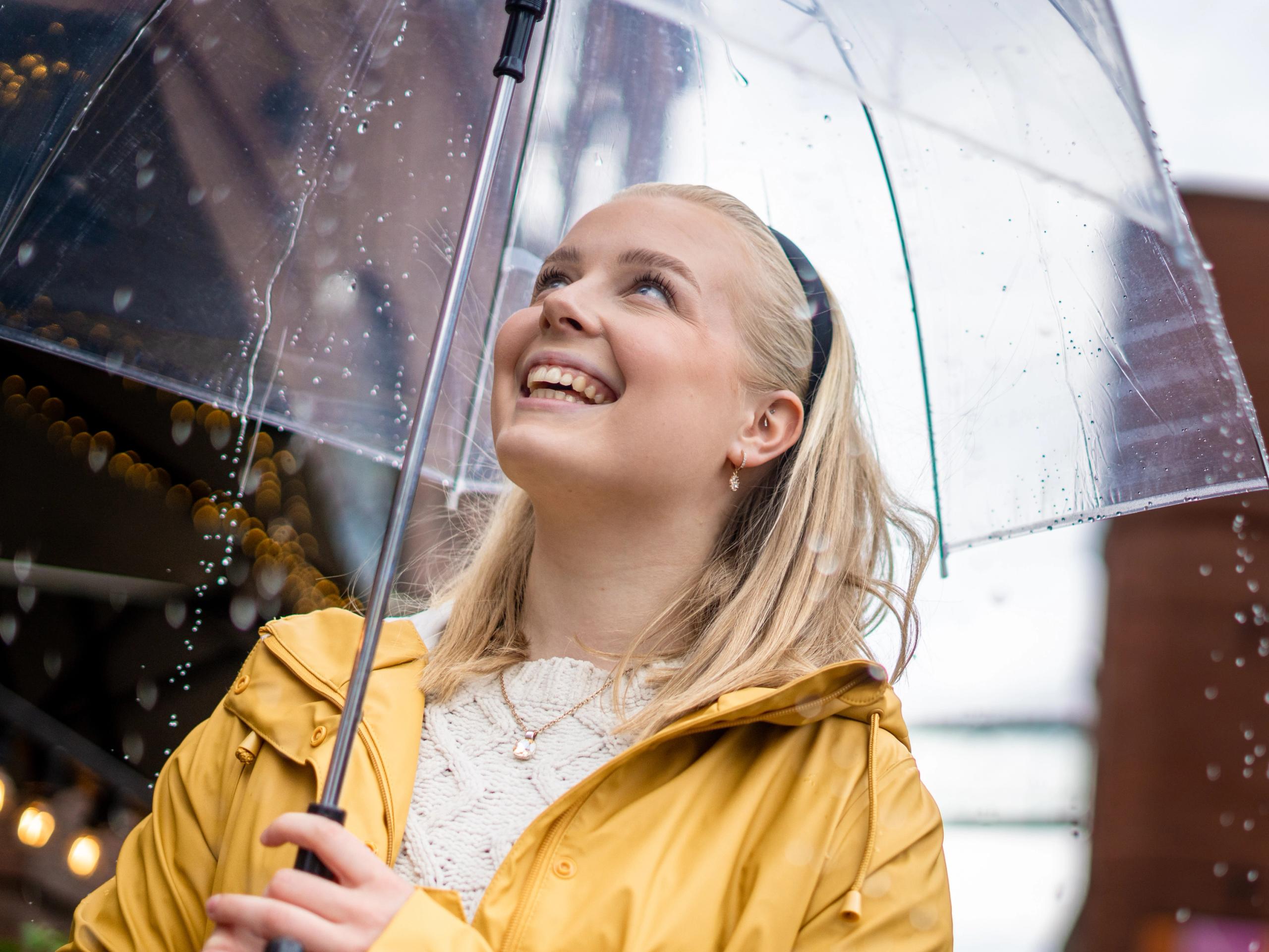 Woman with umbrella on a rainy day at Aker Brygge in Oslo, Eastern Norway