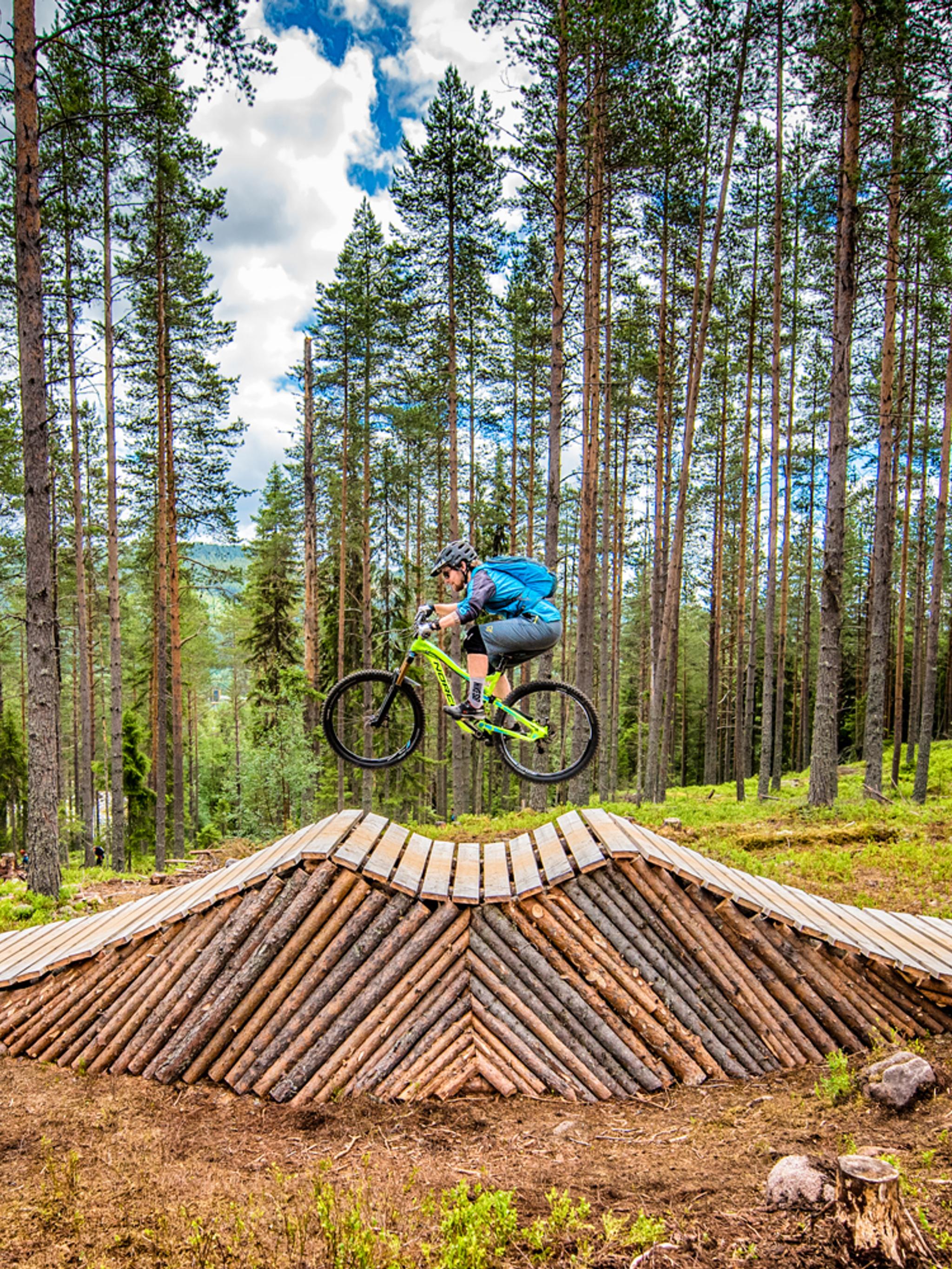 A person cycling on an obstacle in Trysil bike arena in Eastern Norway