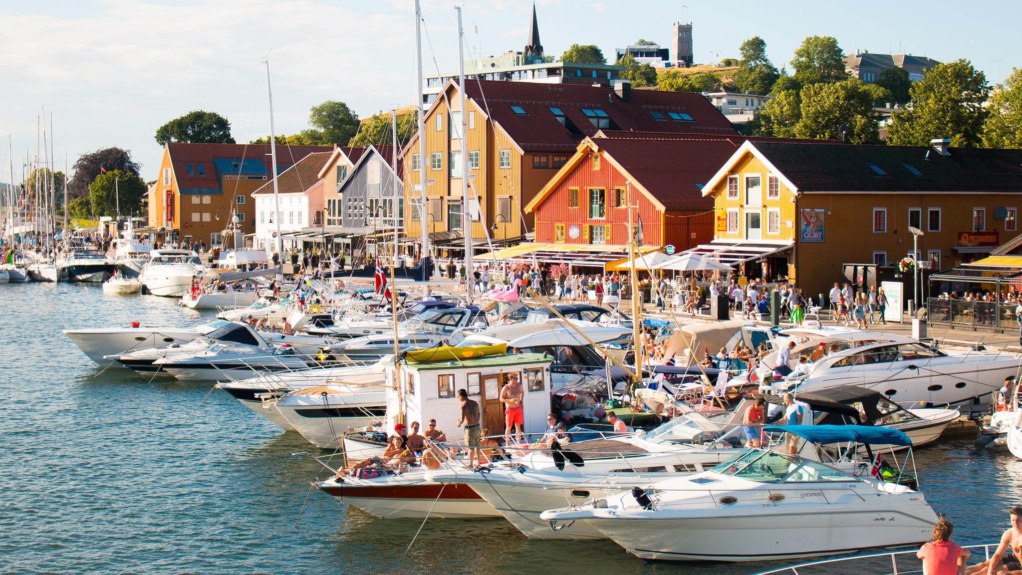 Boats and people in Tønsberg harbour in Vestfold, Eastern Norway, on a sunny summer day