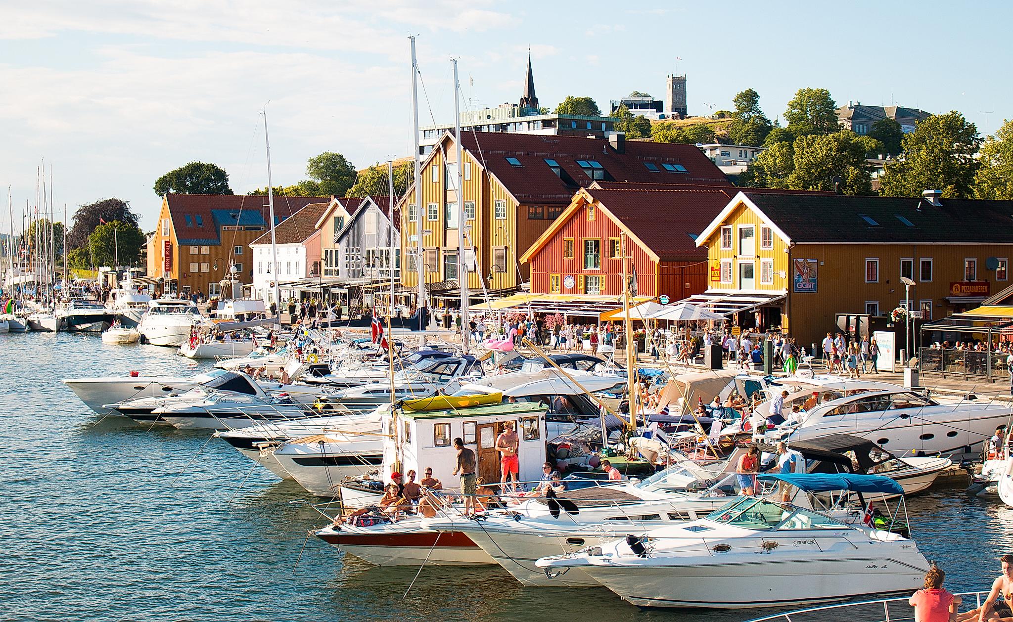 Boats and people in Tønsberg harbour in Vestfold, Eastern Norway, on a sunny summer day