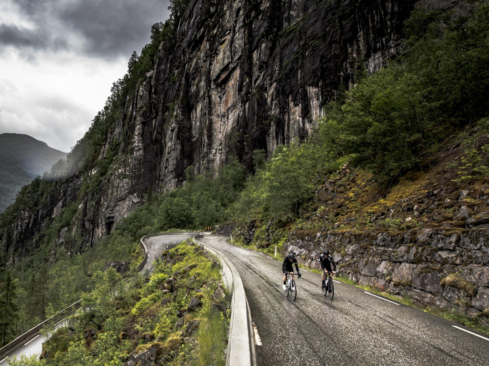 A group of road cyclists in a hairpin bend in Fjord Norway