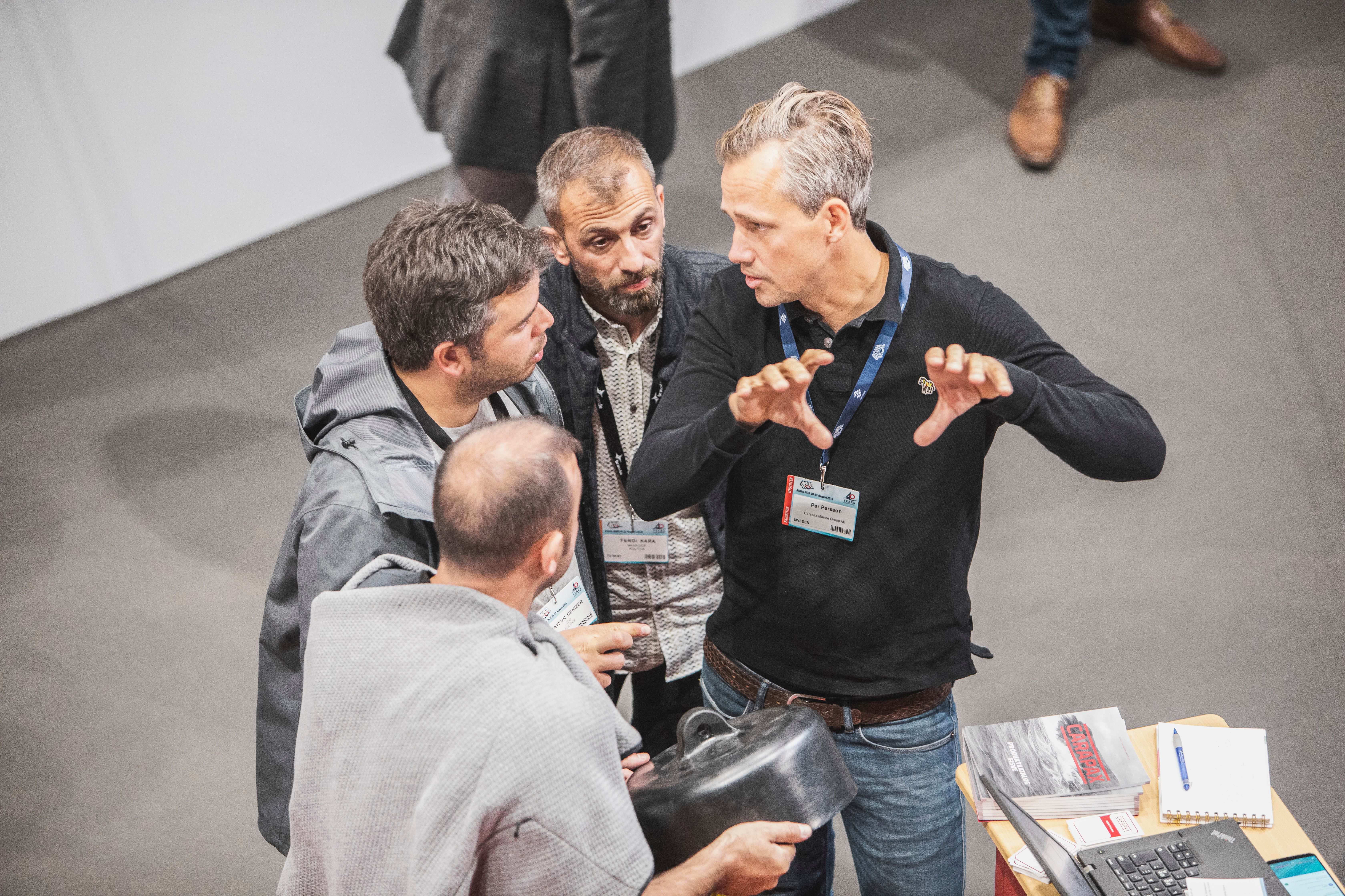 Four men in a conversation during Aqua Nor 2019 in Trondheim, Norway