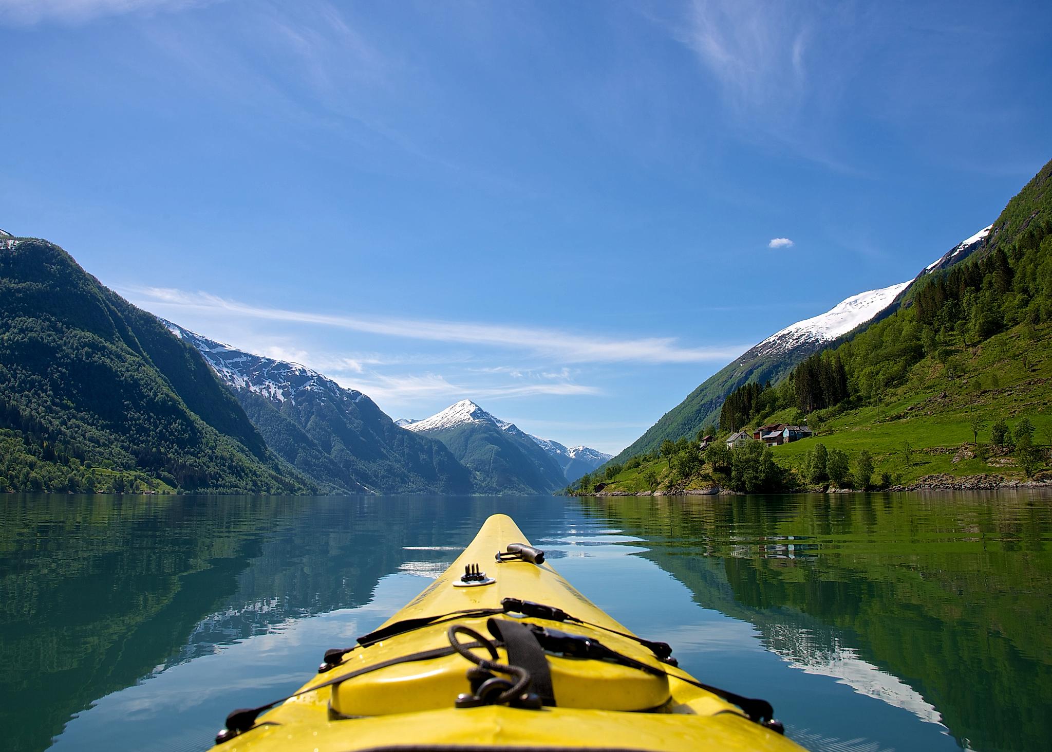 The tip of a kayak on Fjærlandsfjorden in Fjord Norway in a sunny day