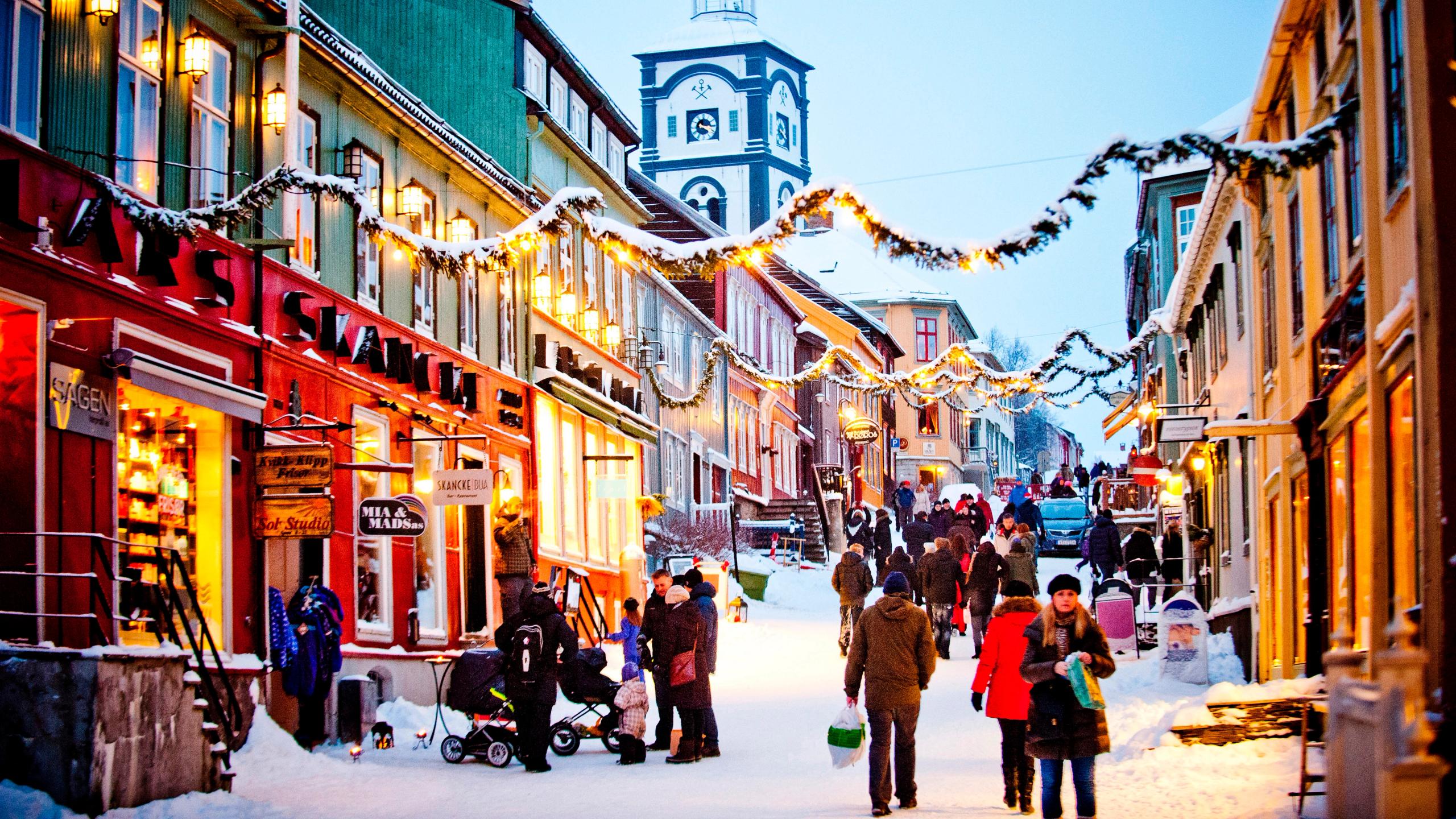People walking in the snowy street during a Christmas market in Røros in Trøndelag, Norway