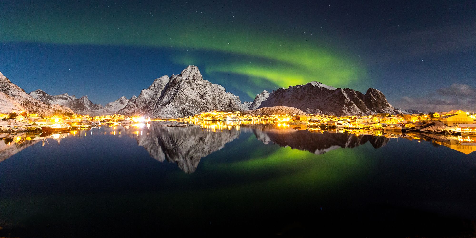 The northern lights over the fishing village Reine in Lofoten, Northern Norway