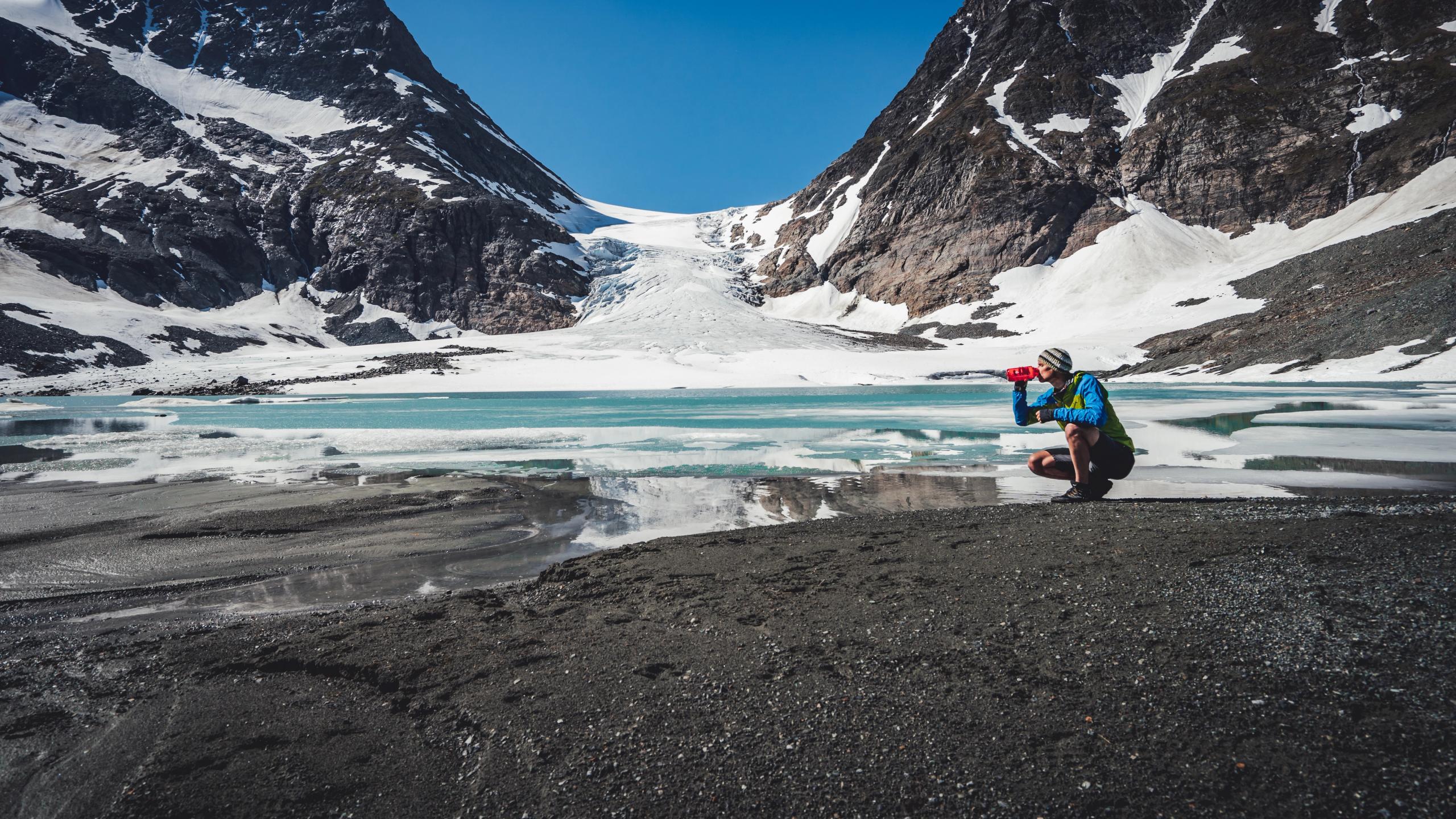 Mann drikker vann fra Steindalsbreen