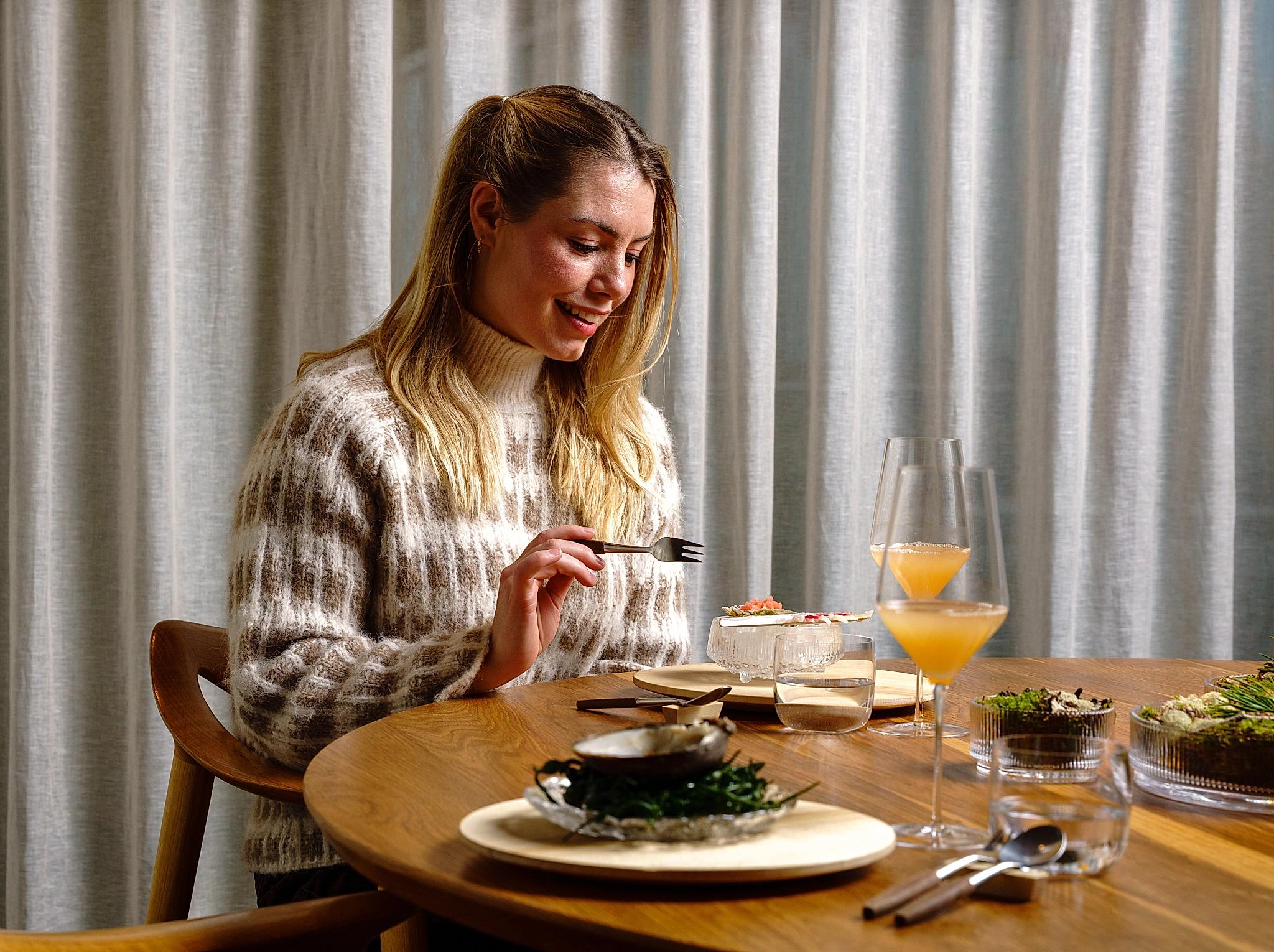 Woman enjoying fine dining from Credo restaurant at The National Library in Oslo