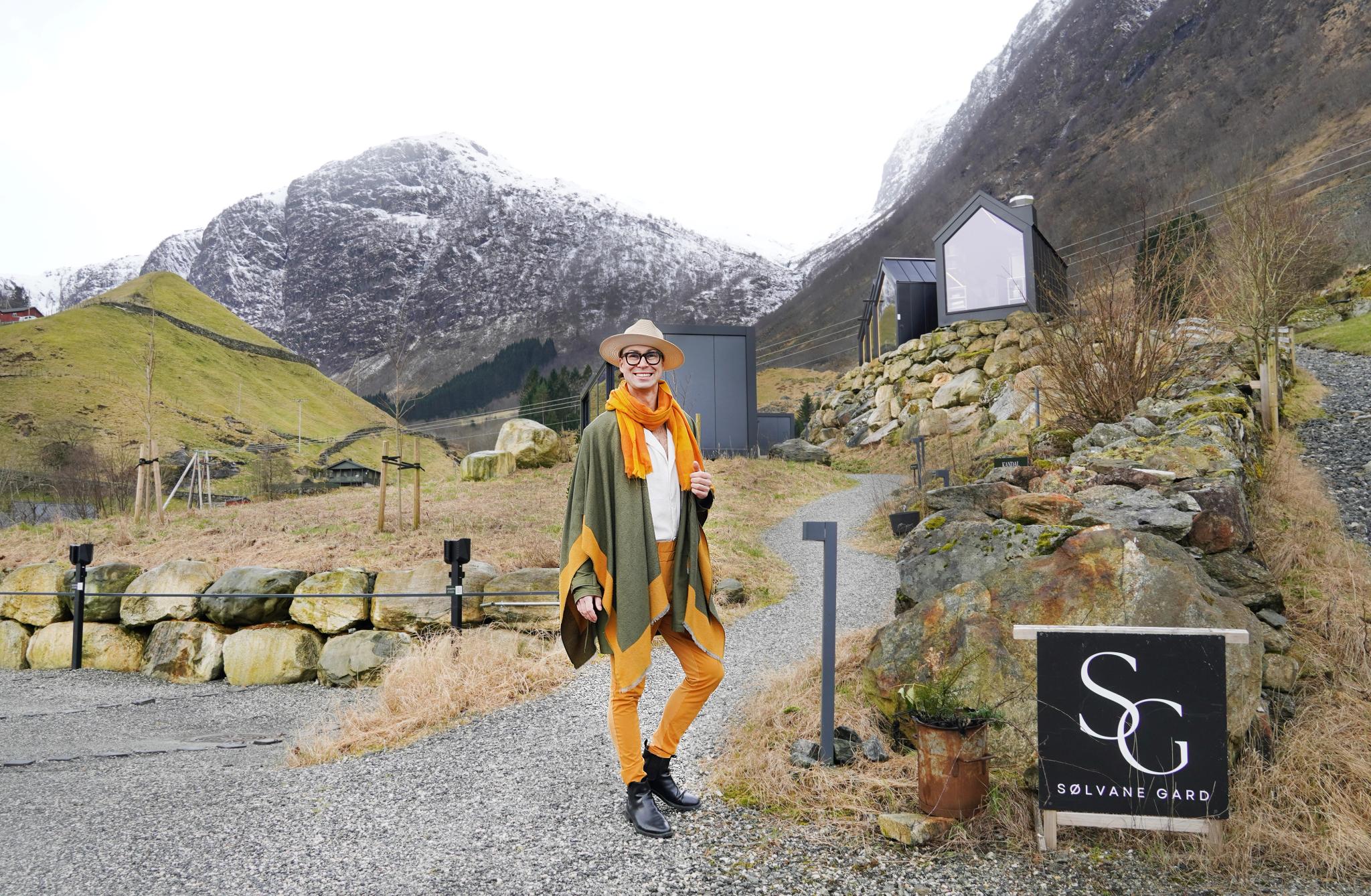 A man in front of the unique cabins in Sølvane Gard in Kandal in Gloppen in Nordfjordeid