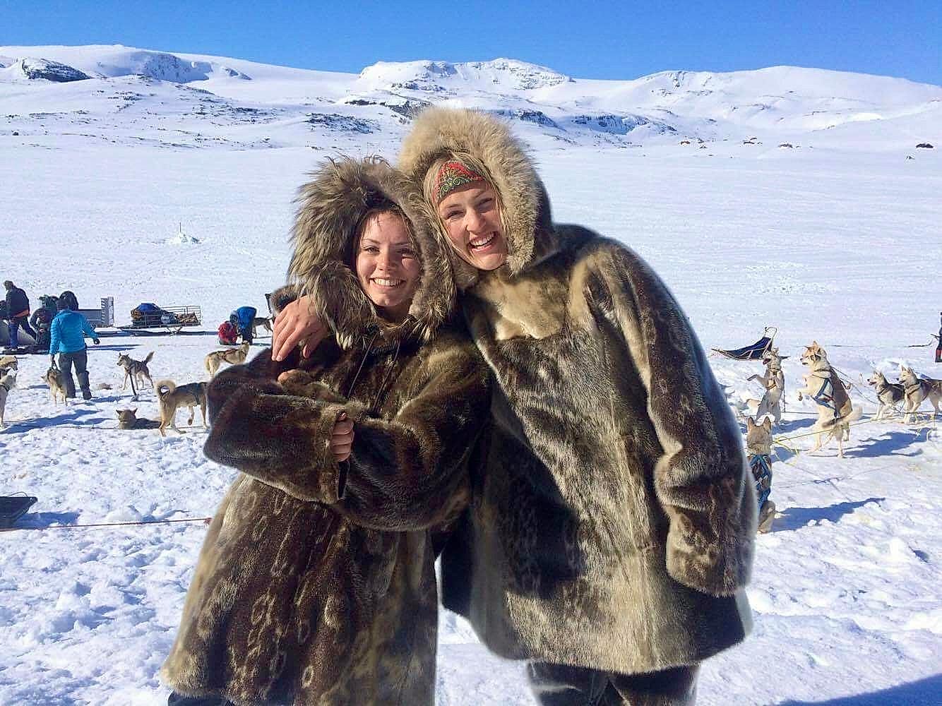 Two women are ready for sled dog racing in the snowy landscape at Finse