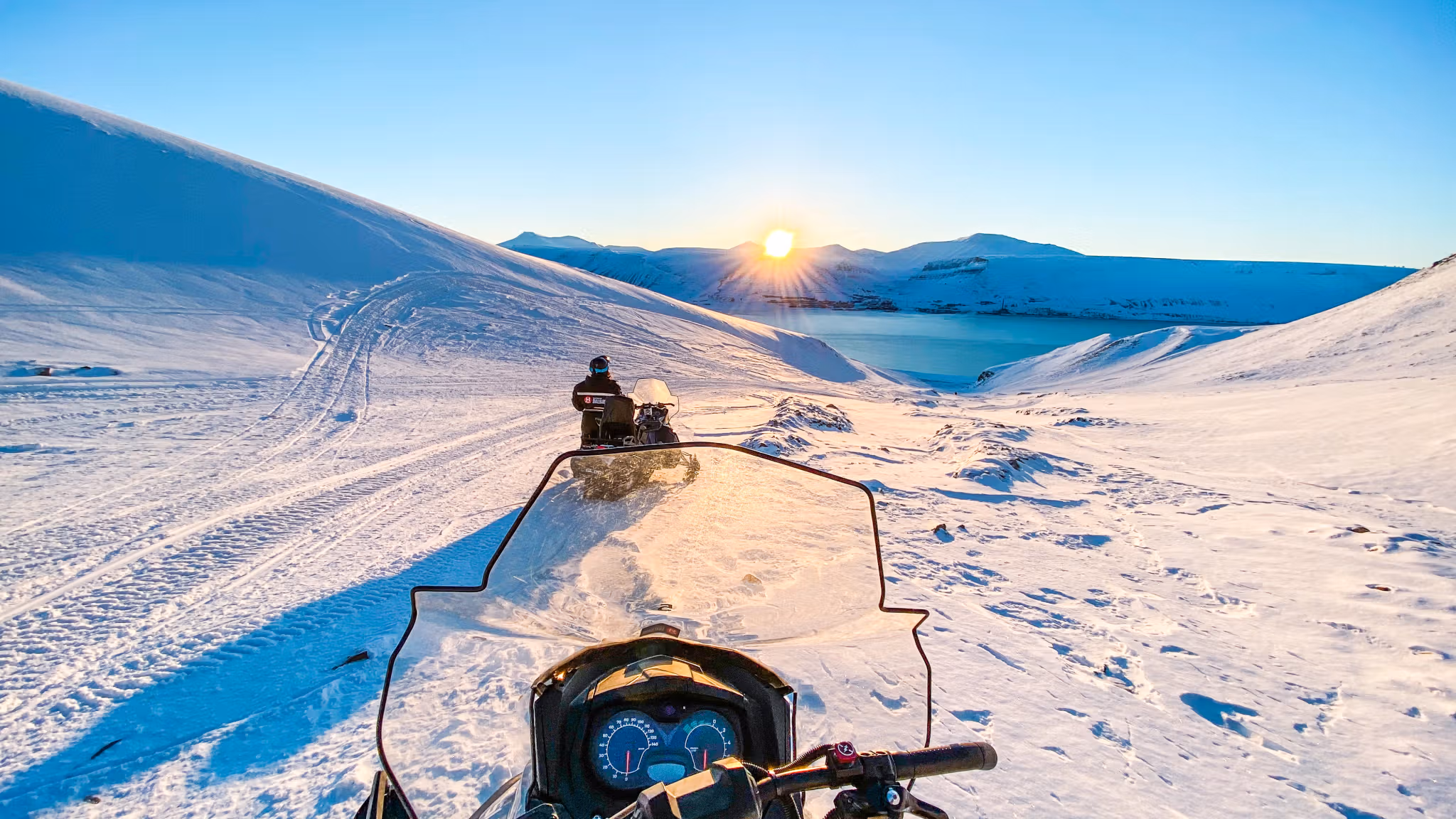 A sunset on Svalbard seen from an electric snowmobile