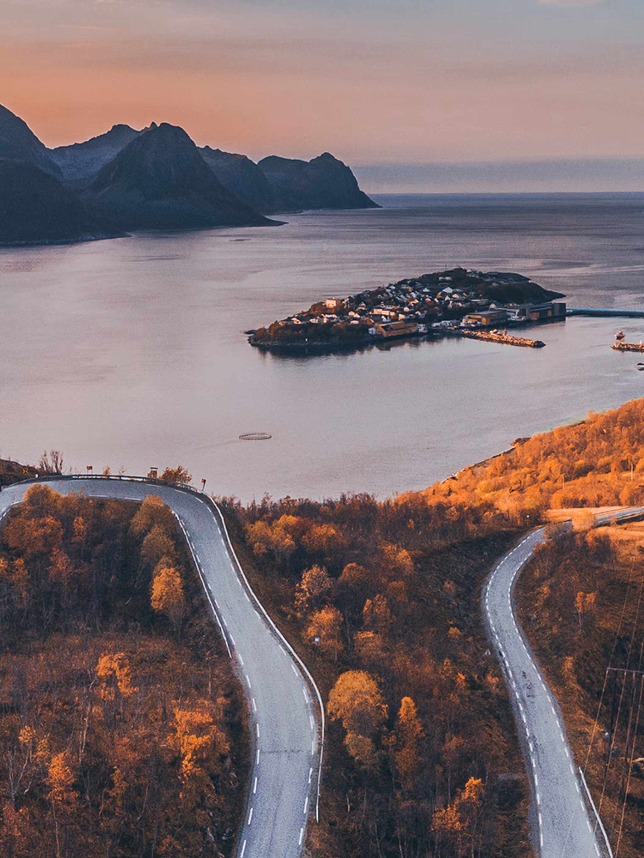 Tiny village of Husøy and winding roads in Senja