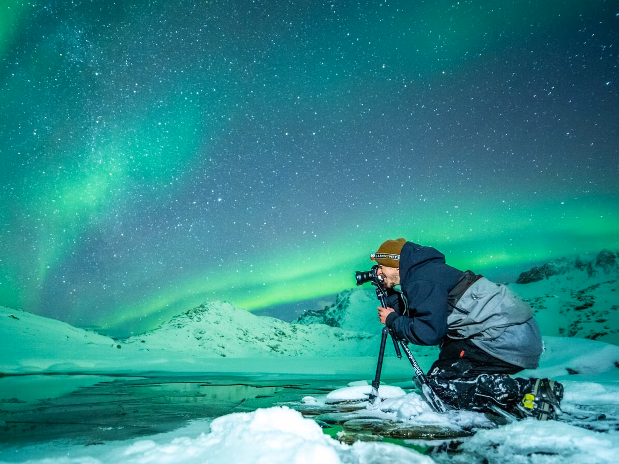 Person taking picture of the northern lights in Northern Norway