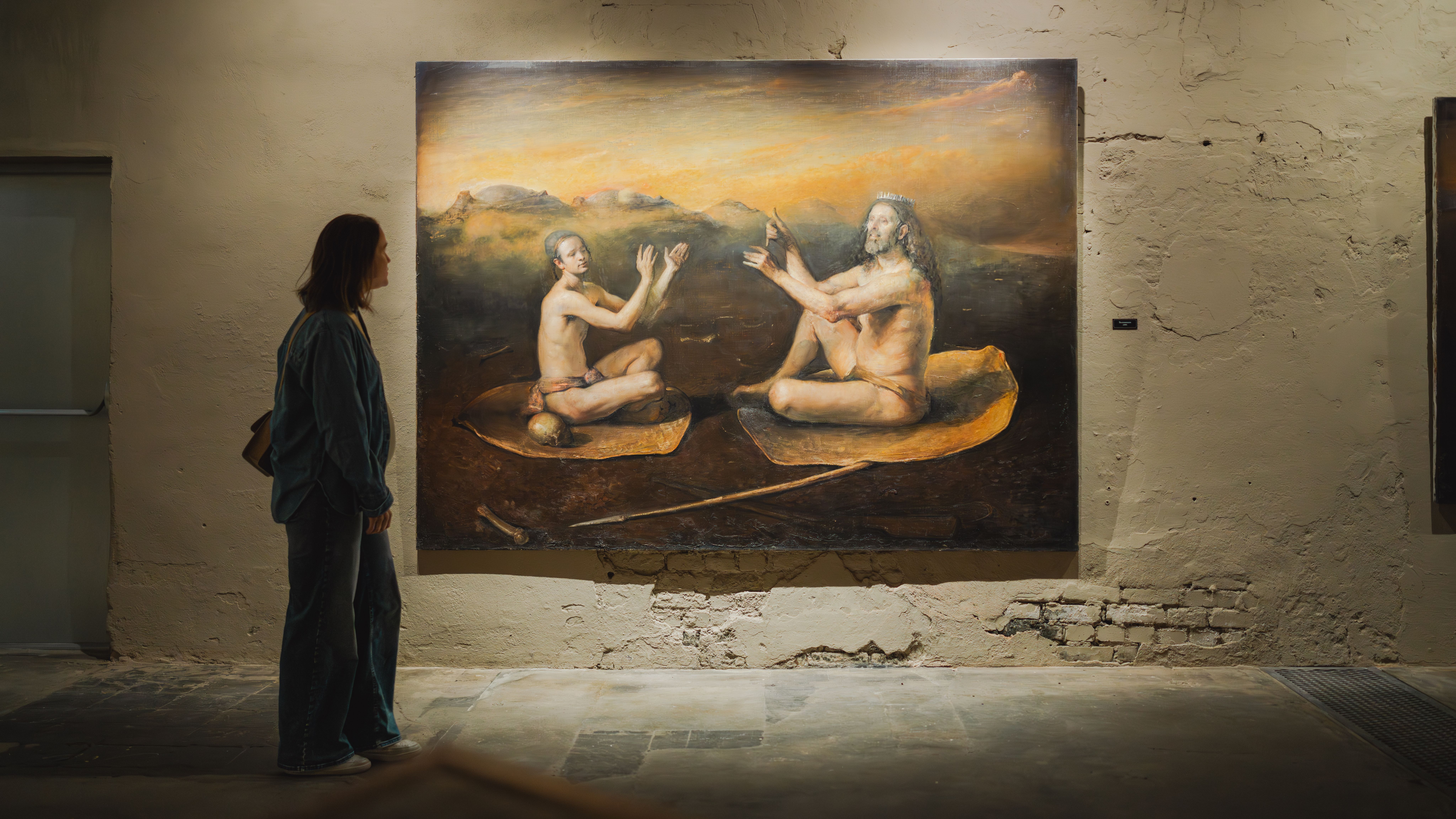 A woman looking at art in a gallery.