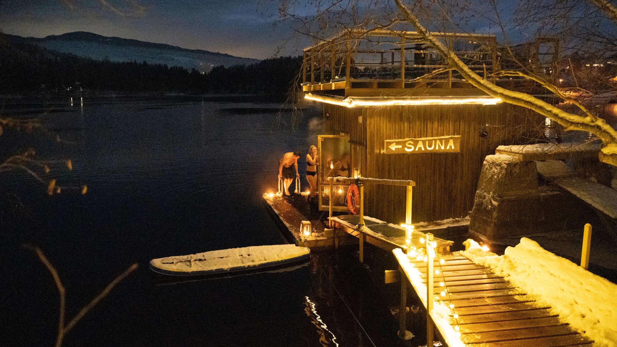 People entering a sauna after swimming.