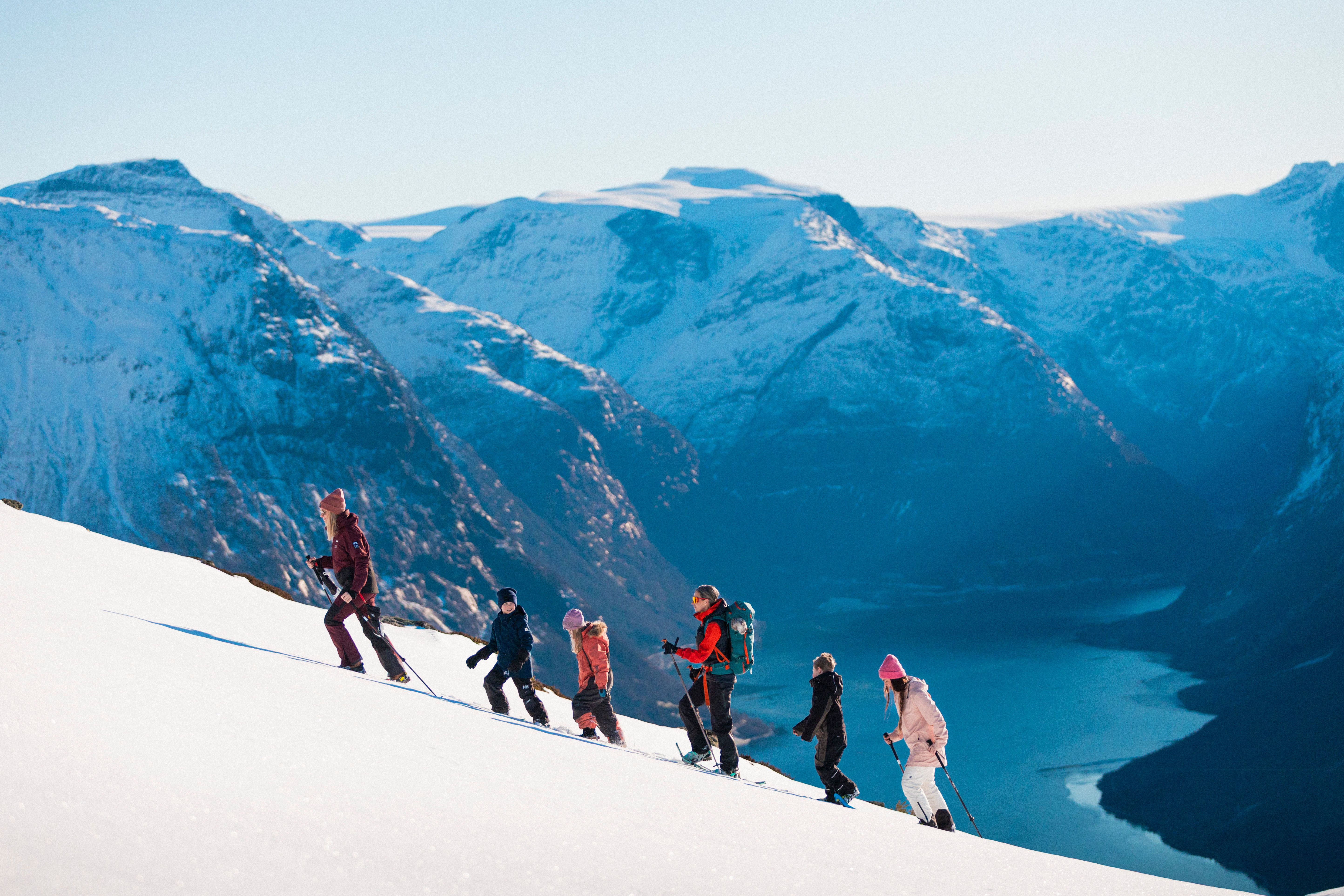 People snowshoeing up a mountain.