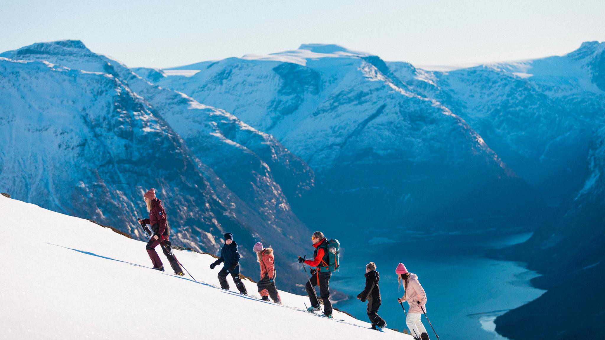 People snowshoeing up a mountain.