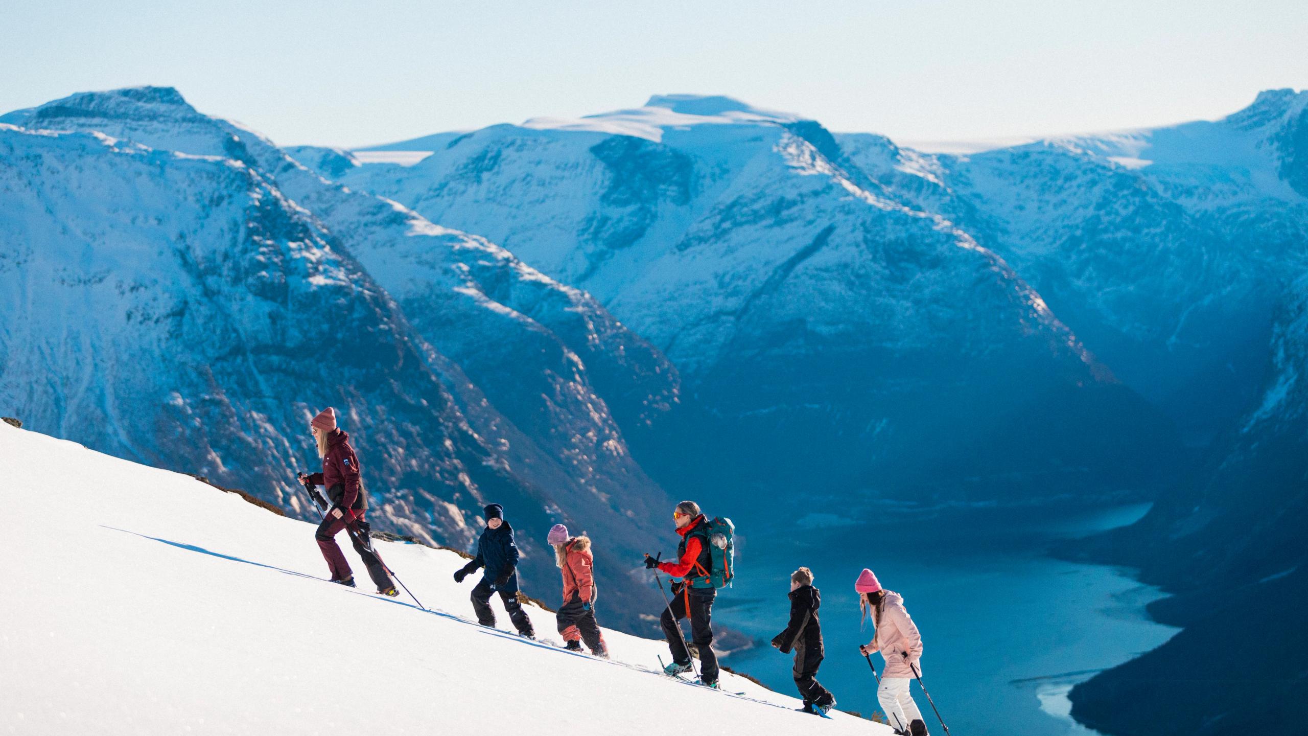 People snowshoeing up a mountain.