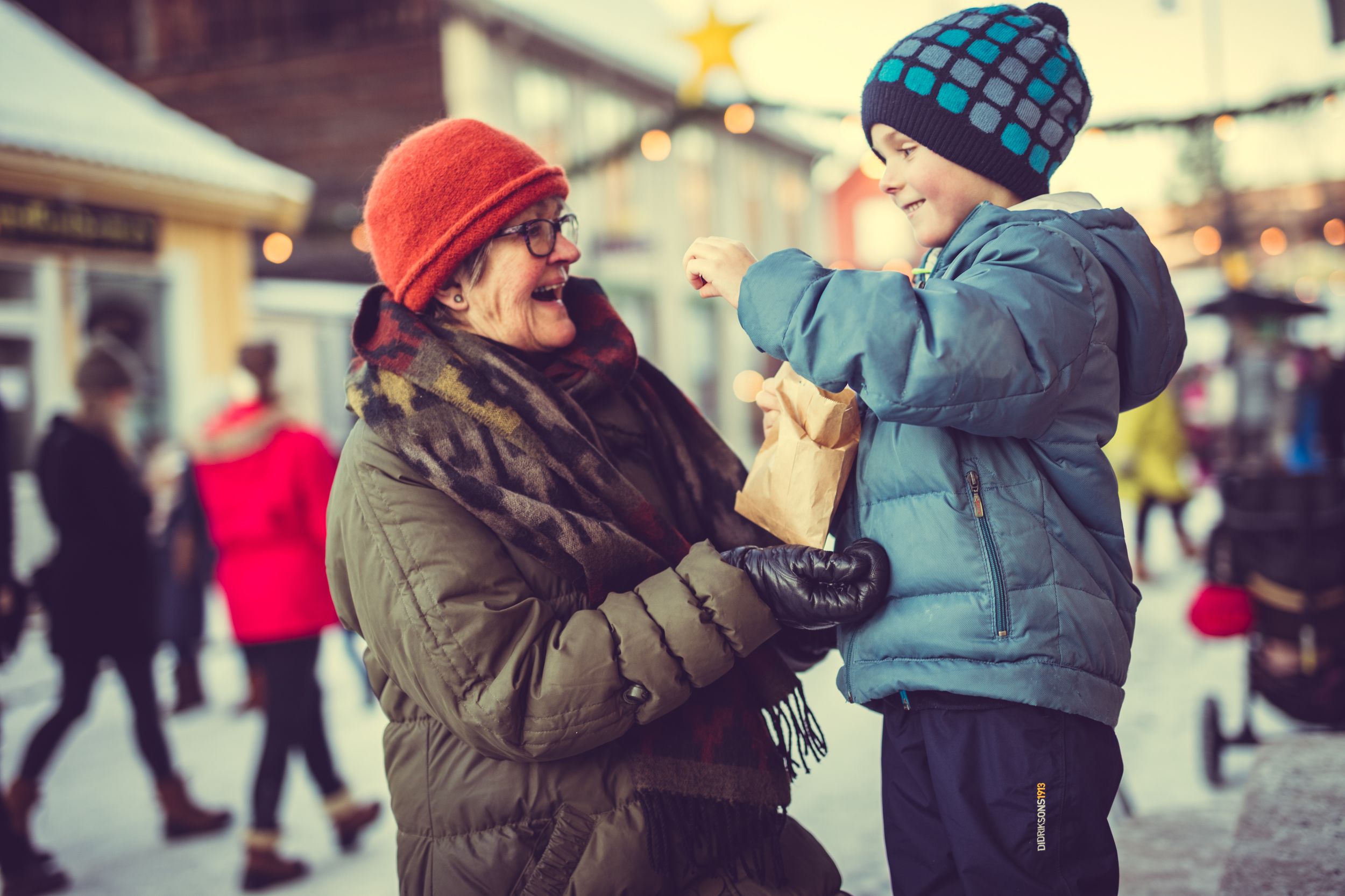 Elderly woman and little boy at Christmas market at Maihaugen Museum in Lillehammer
