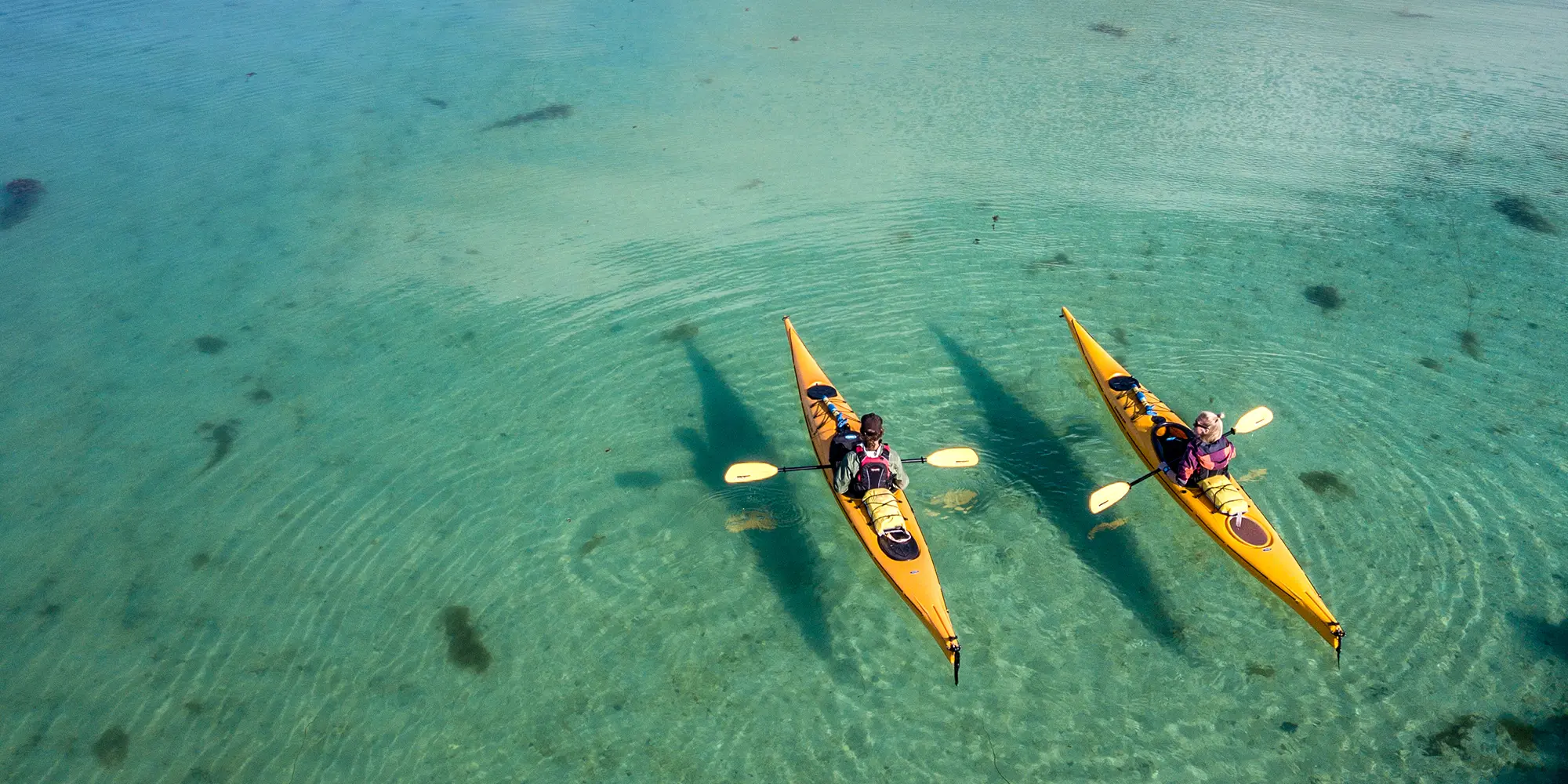 Zwei Kajakfahrer auf dem Wasser in der Nähe von Herøy in Helgeland, Nordnorwegen.