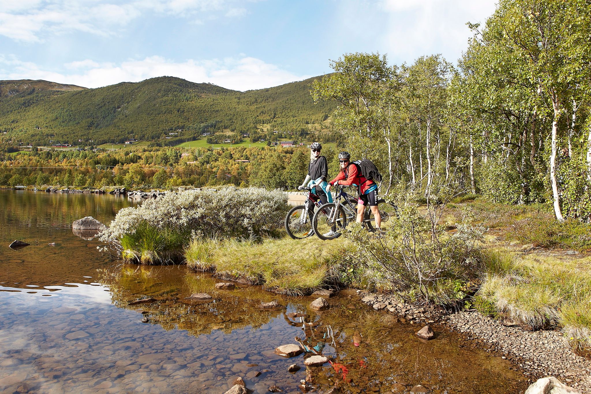 A couple biking the Ustedalsfjord Round in Geilo, Eastern Norway