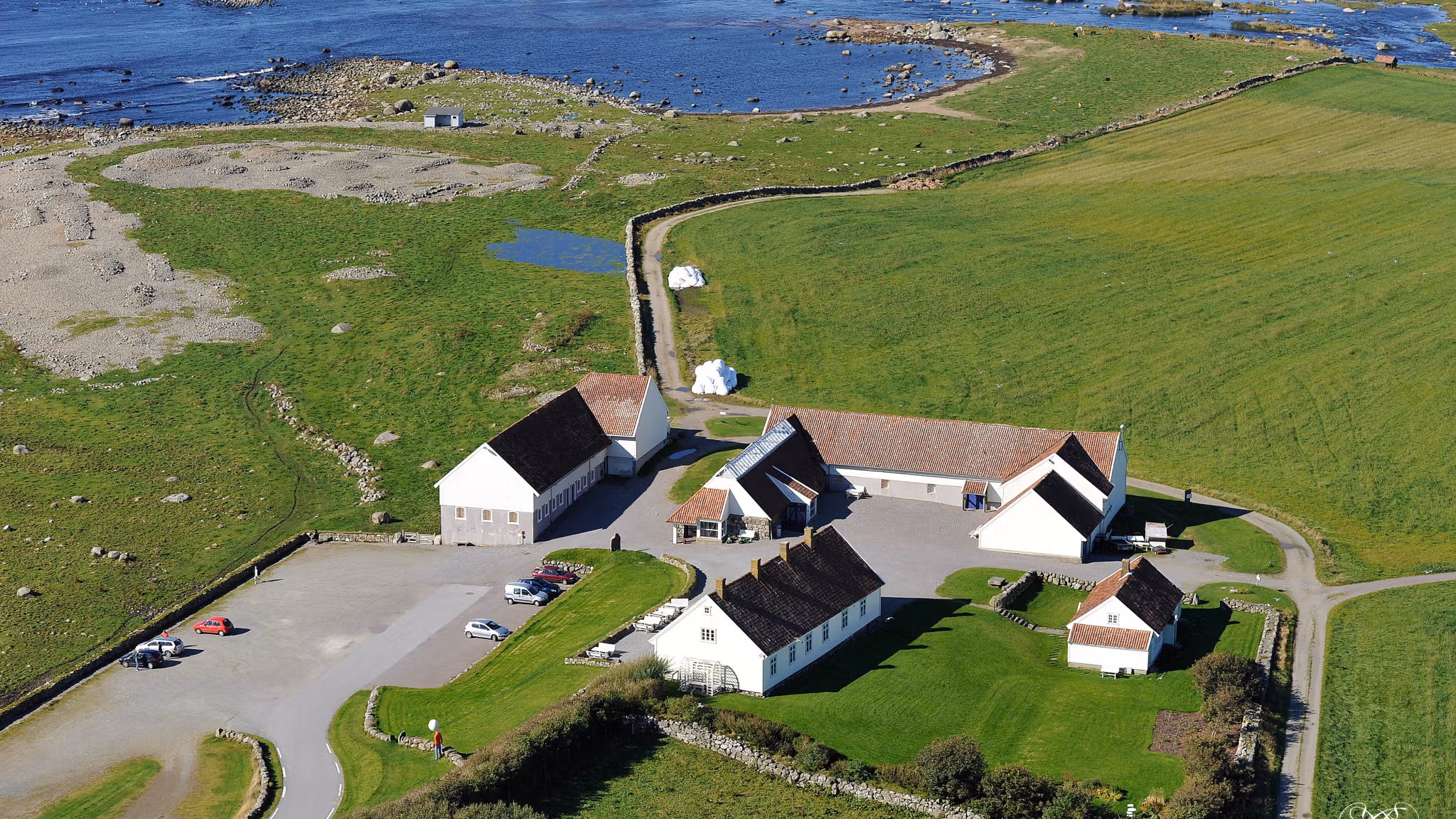 Hå Gamle Prestegard and Obrestad lighthouse by the coast.