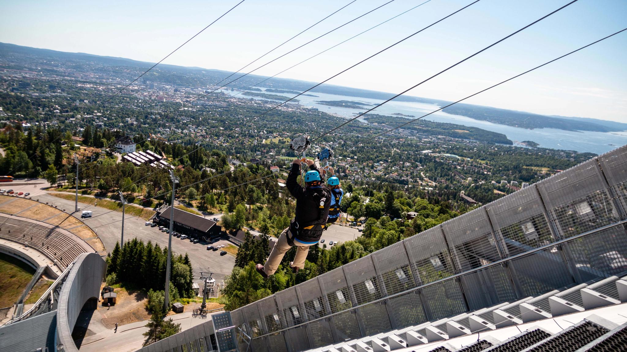 A person taking the zip line from the Holmenkollen Ski jump in Oslo.