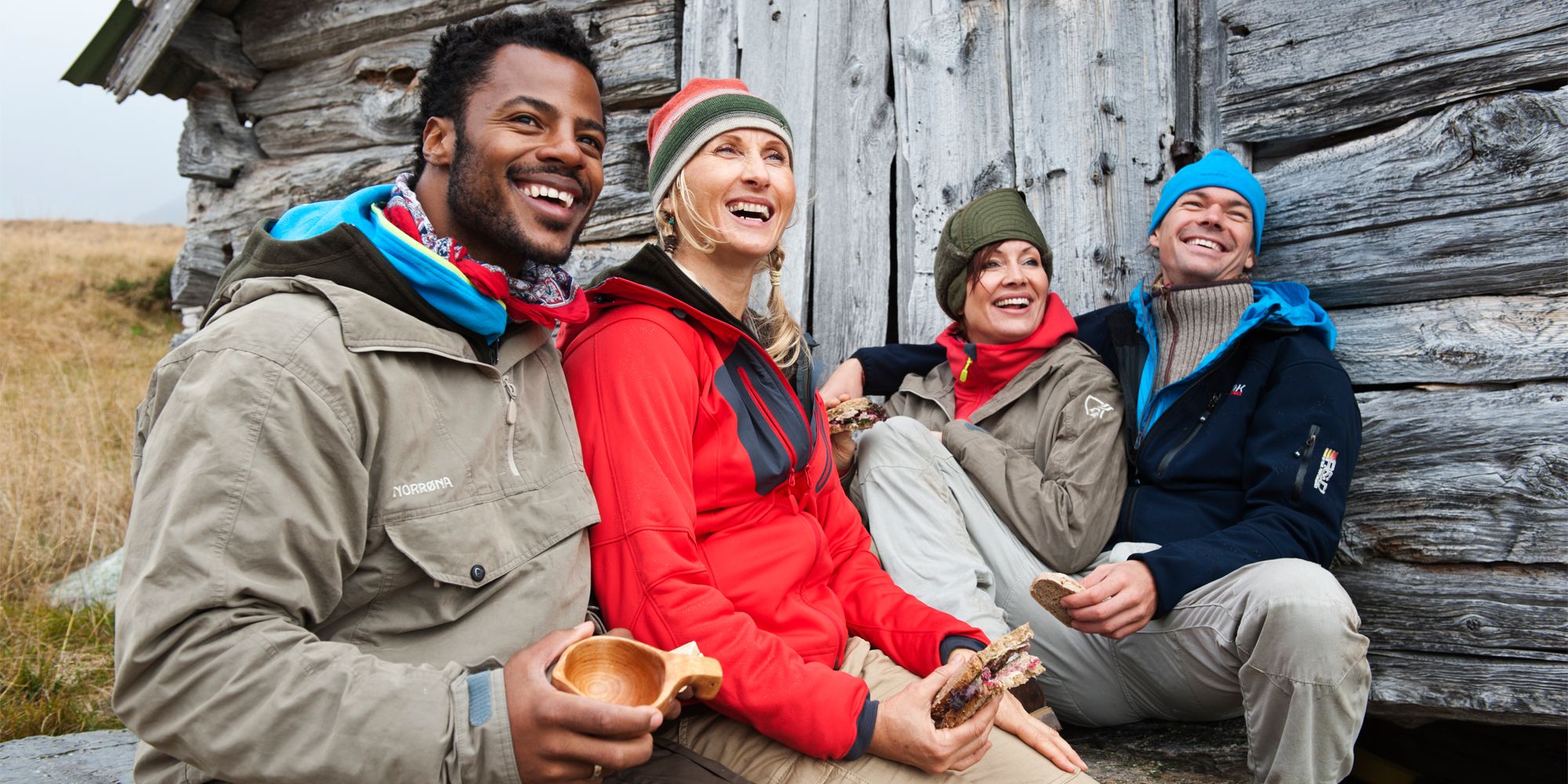 Four people resting outside of a mountain cabin in Beitostølen, Norway