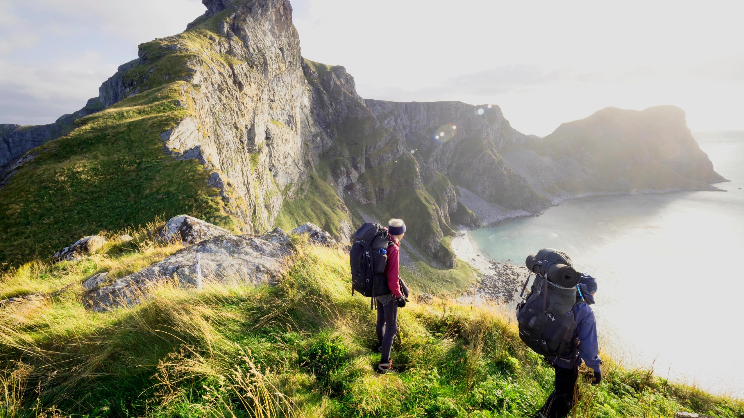 Two people hiking in Værøy in the Lofoten Islands in Northern Norway