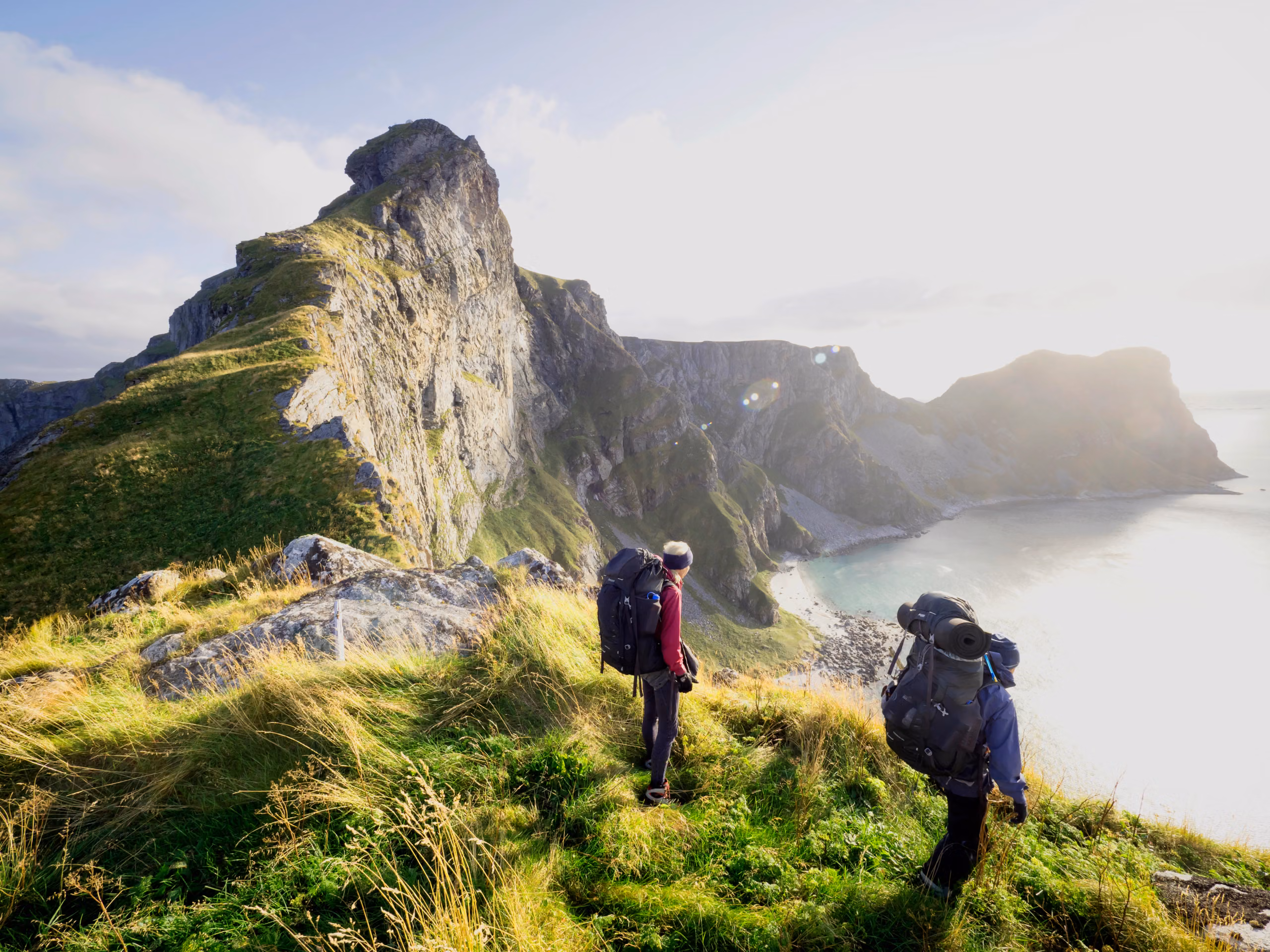 Two people hiking in Værøy in the Lofoten Islands in Northern Norway