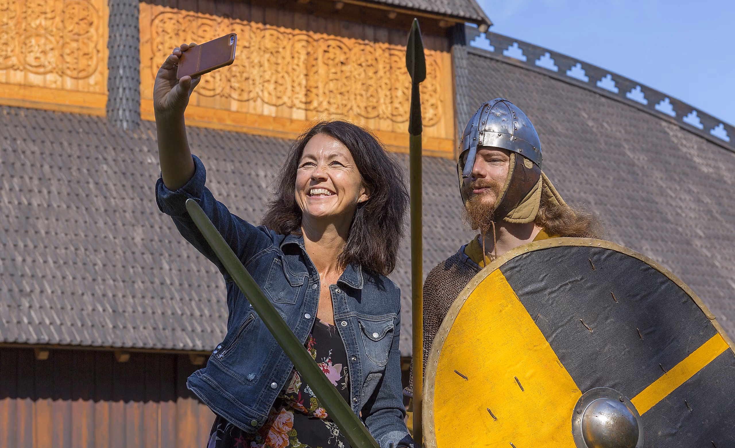 A woman takes a selfie with a Viking at Midgard viking centre in Borre in Vestfold, Eastern Norway