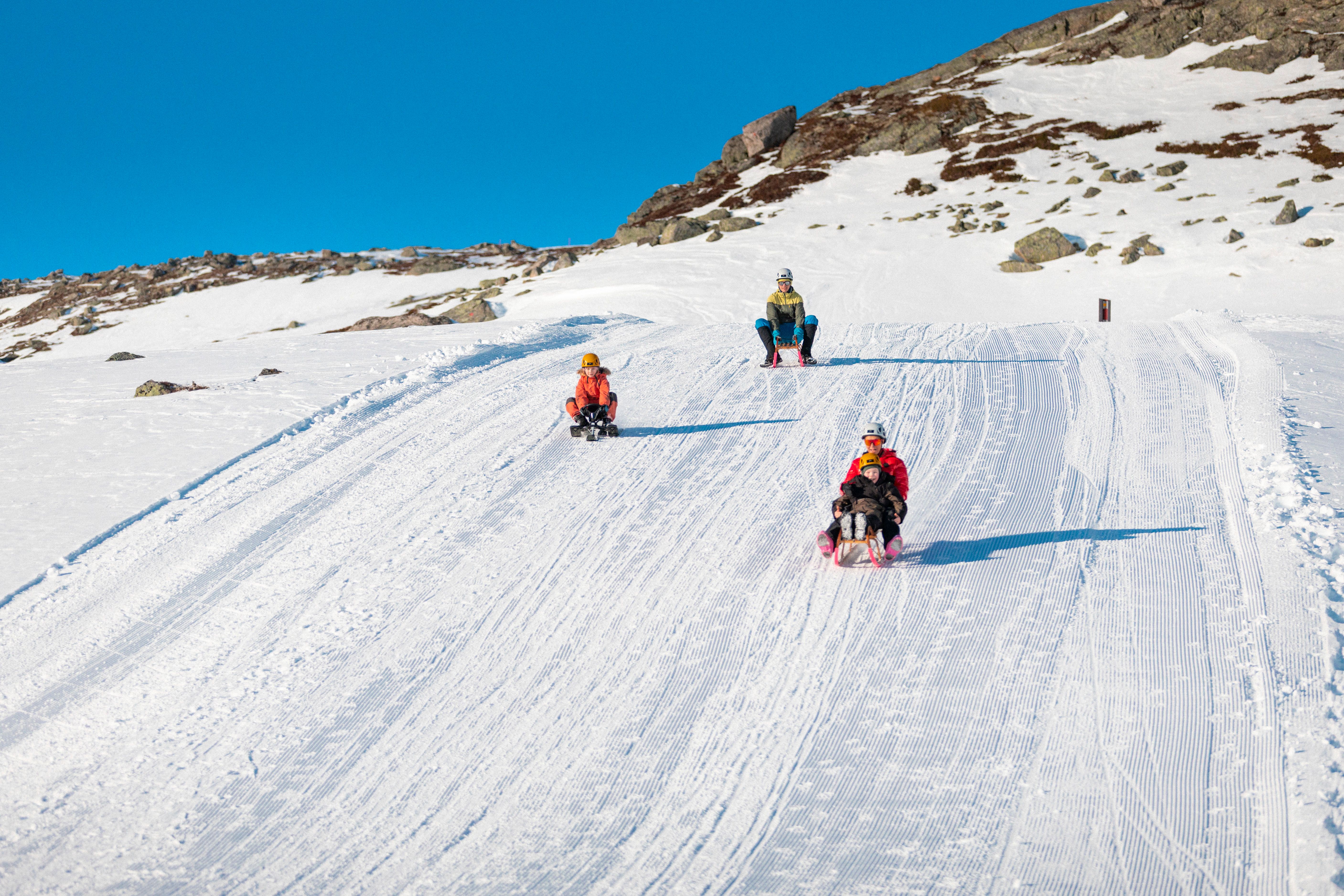 People sledding down a mountain.