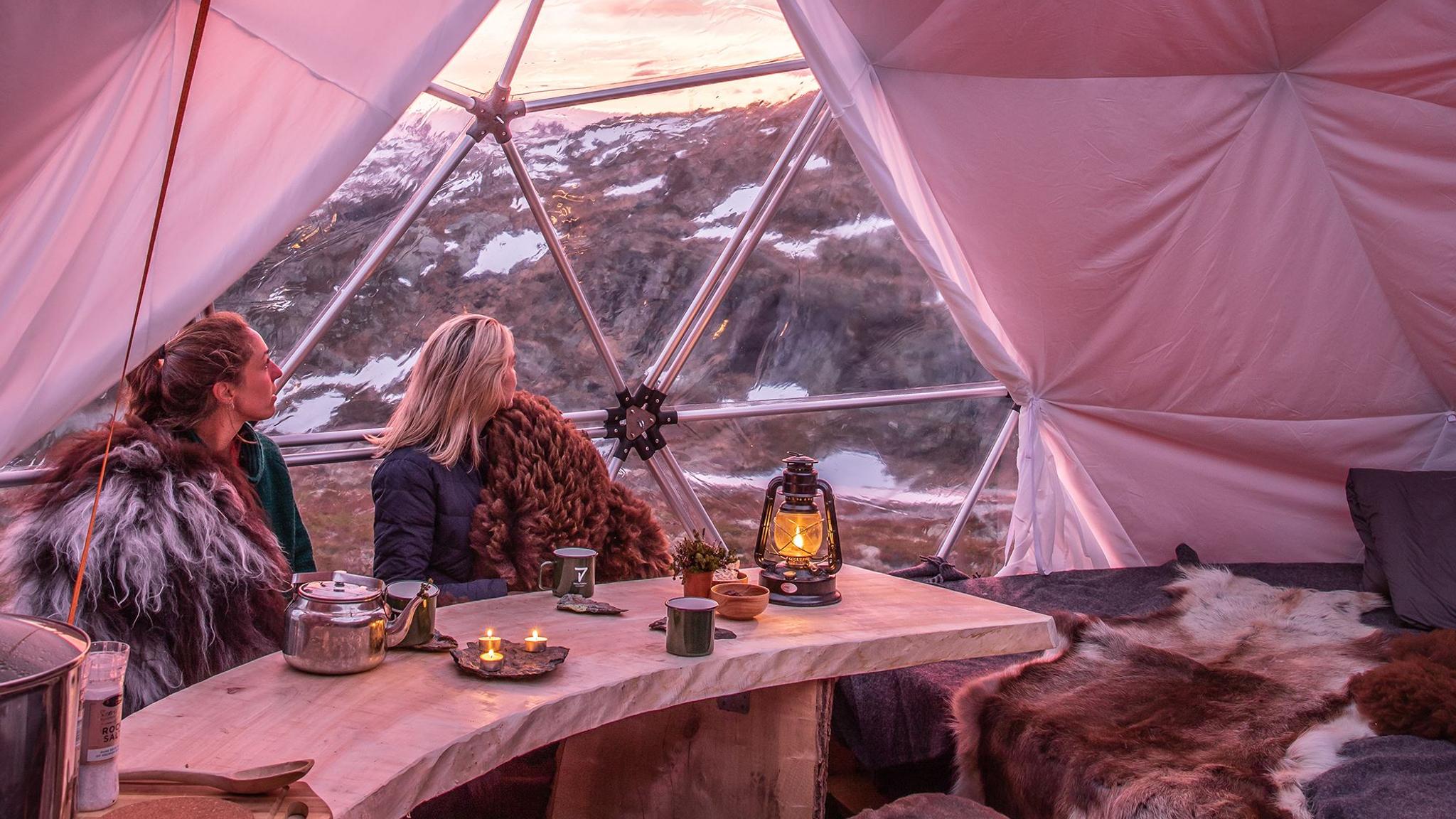 People enjoying the view from inside the sunset dome with glass ceiling