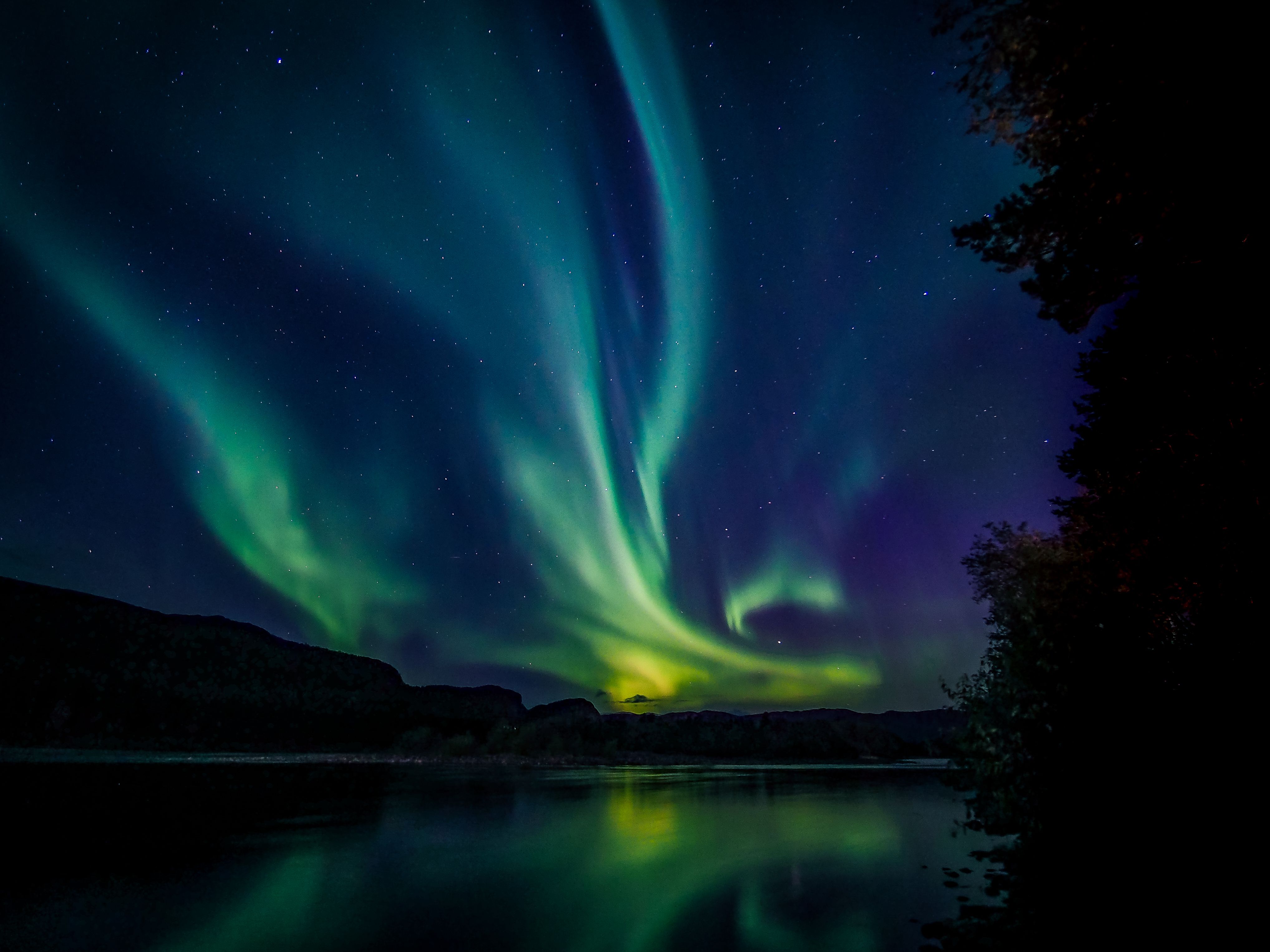 Northern lights over mountains.