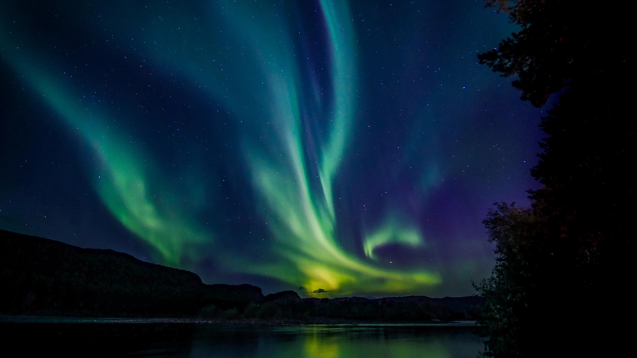 Northern lights over mountains.