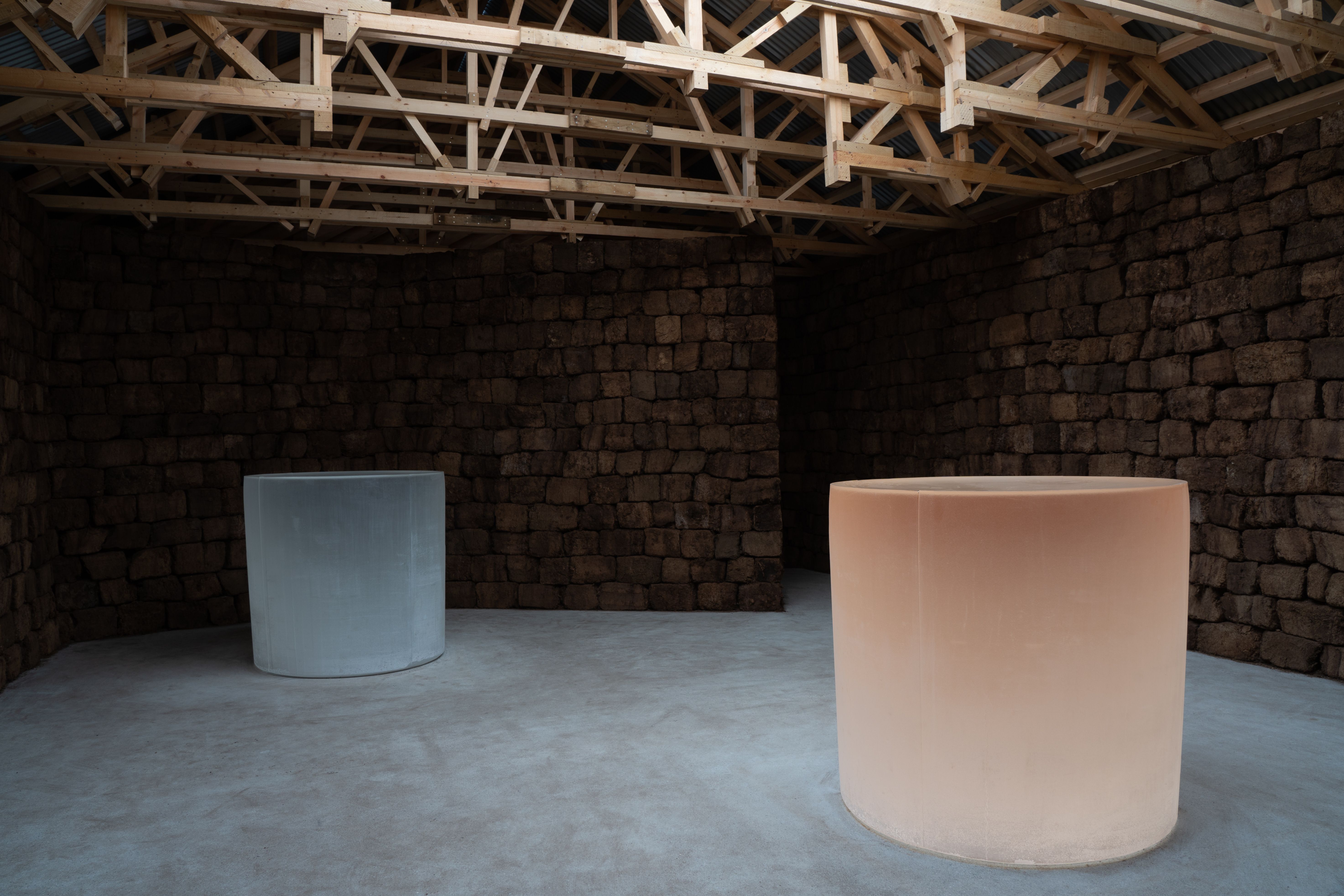 Roni Horn's art installation consists of two large cylindrical glass objects housed in an architect-designed wooden building