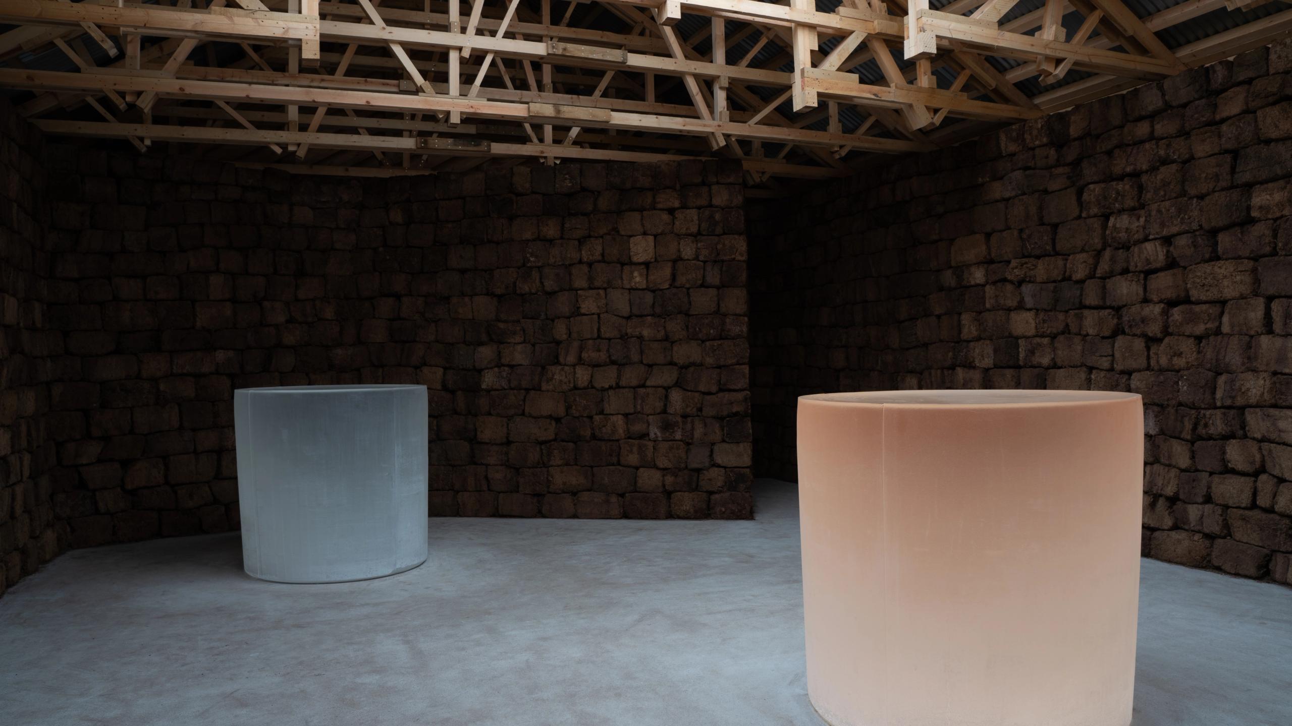 Roni Horn's art installation consists of two large cylindrical glass objects housed in an architect-designed wooden building