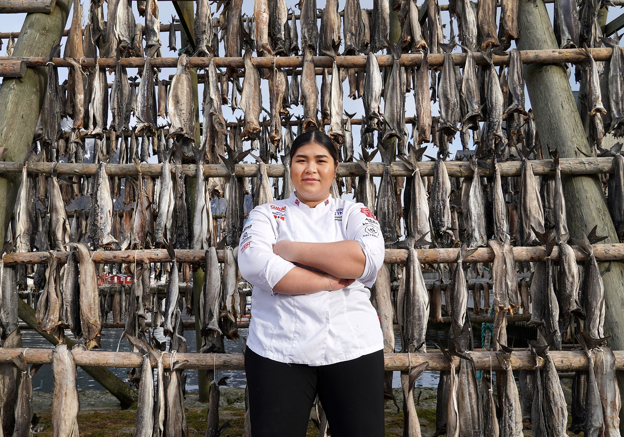 Young woman in front of pollock stockfish.