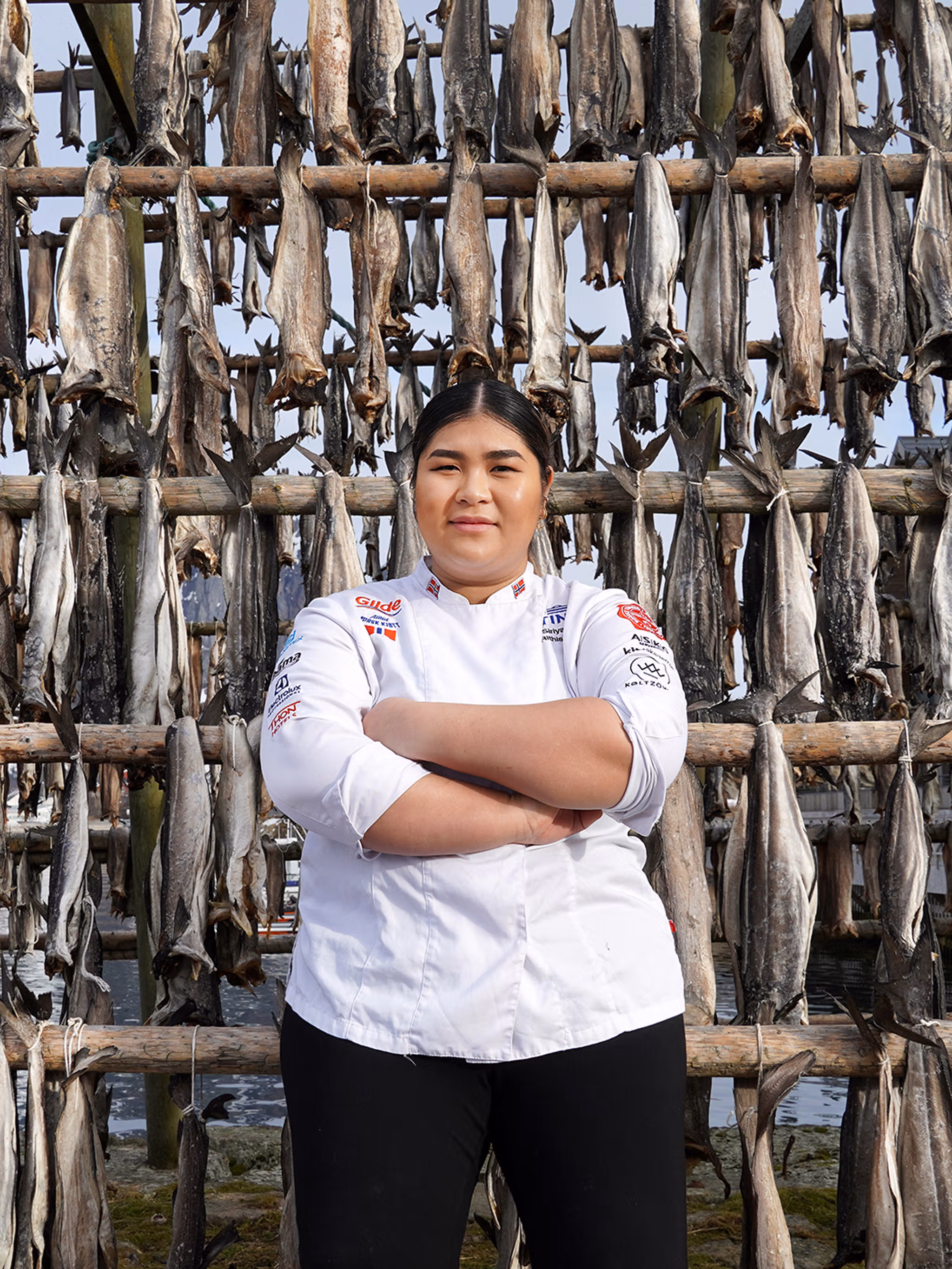 Young woman in front of pollock stockfish.