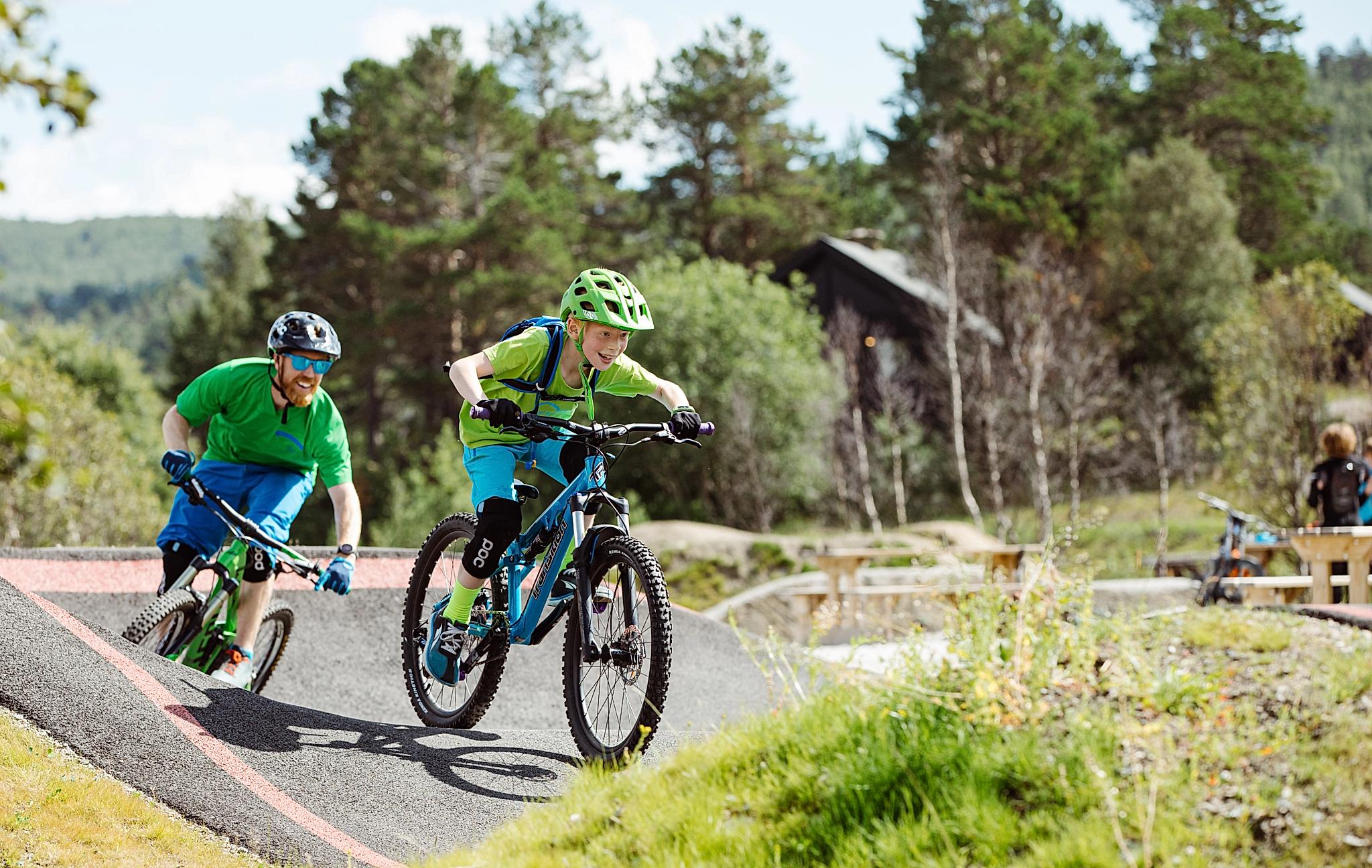 Father and son mountain biking in Hallingdal, Eastern Norway