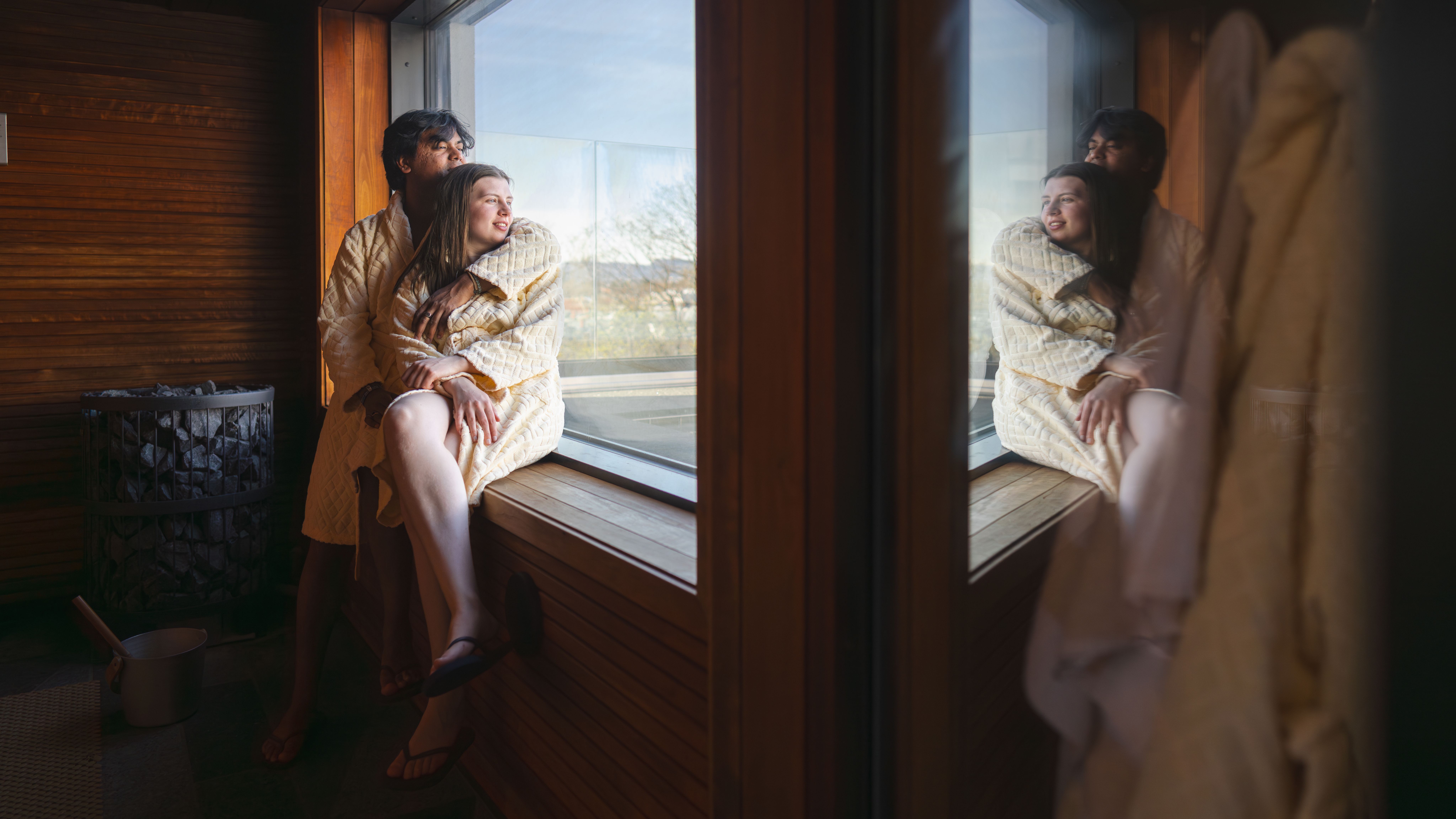 A couple enjoying the view from inside a sauna