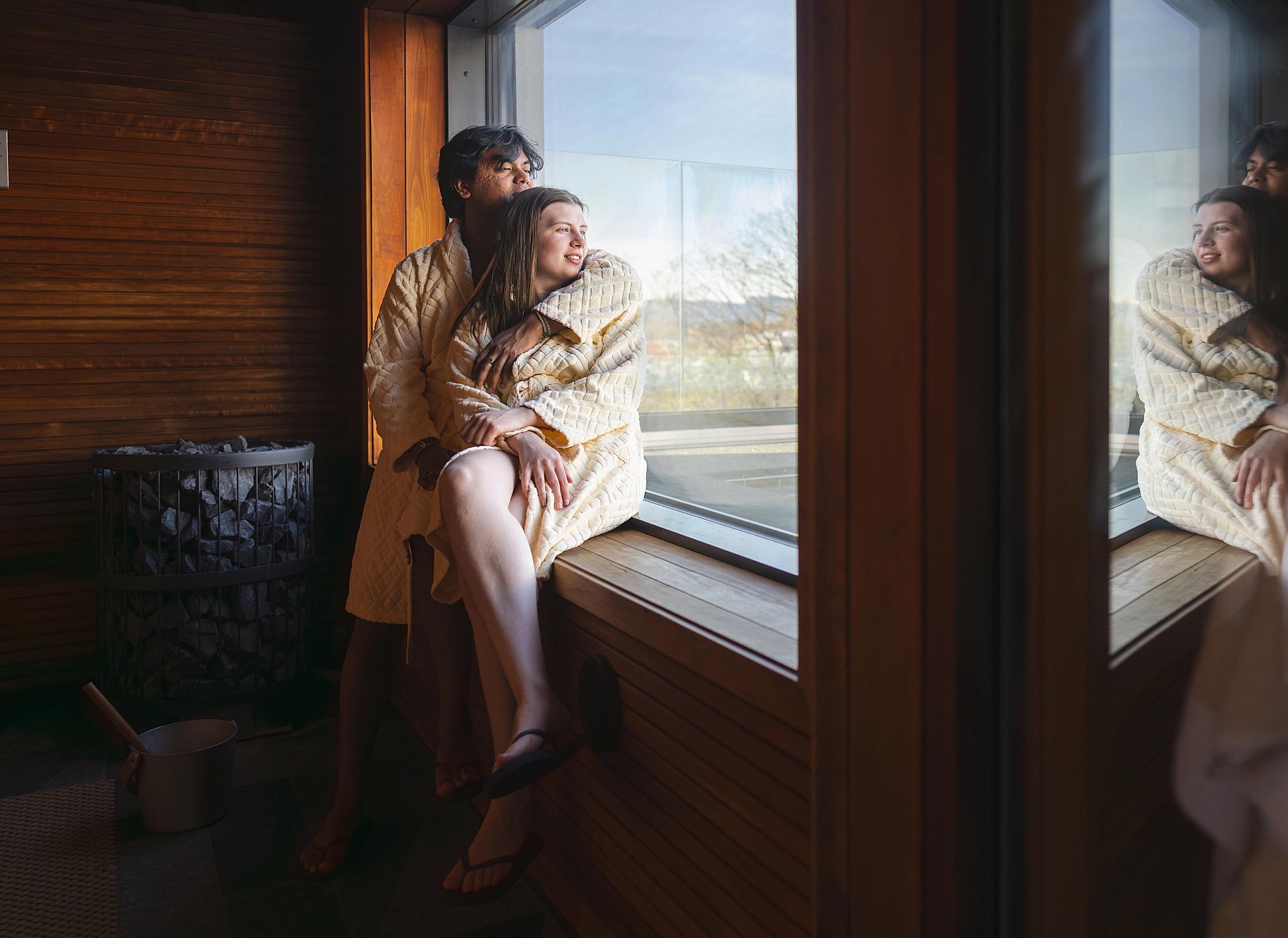 A couple enjoying the view from inside a sauna