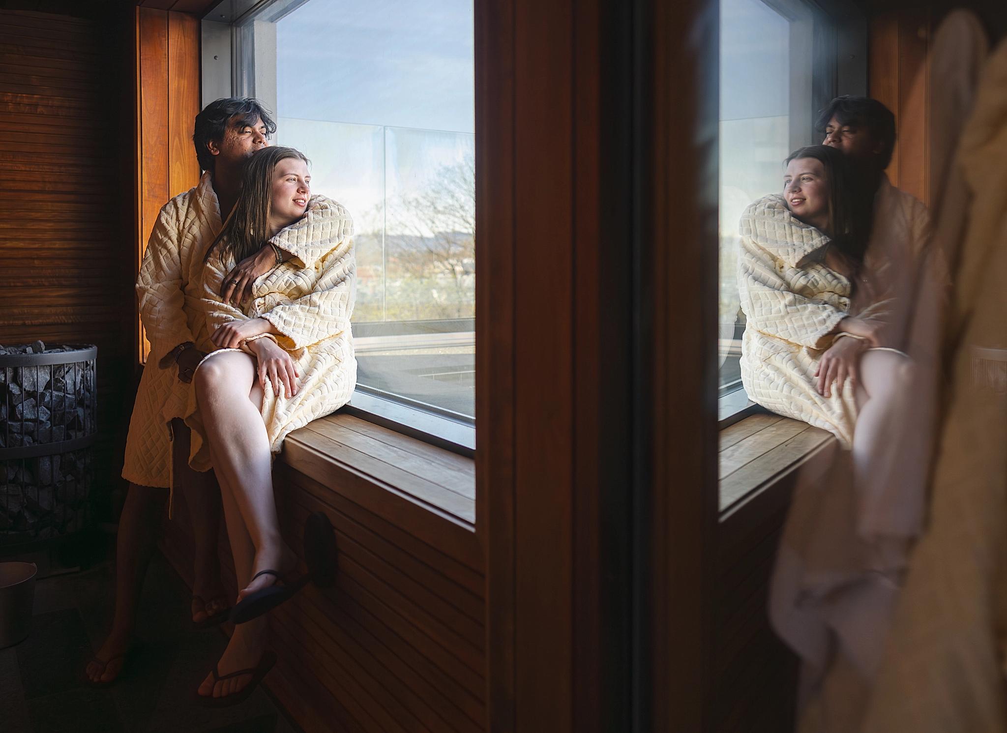 A couple enjoying the view from inside a sauna