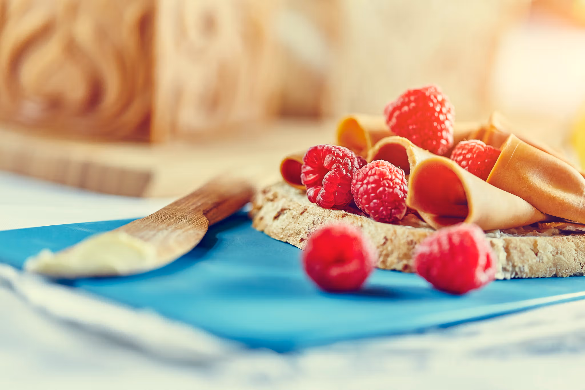 A slice of bread with brown cheese and berries in Norway