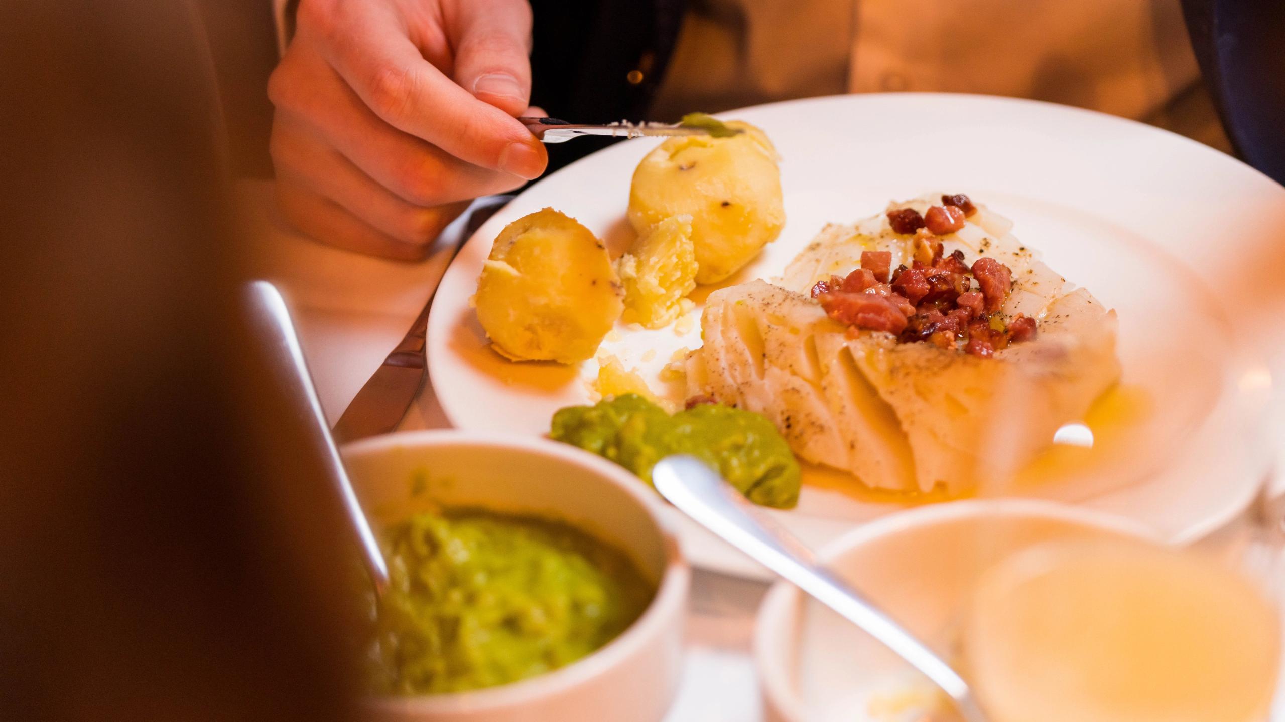 A plate of lutefisk with potatoes, bacon and pea stew at Gamle Raadhus Restaurant